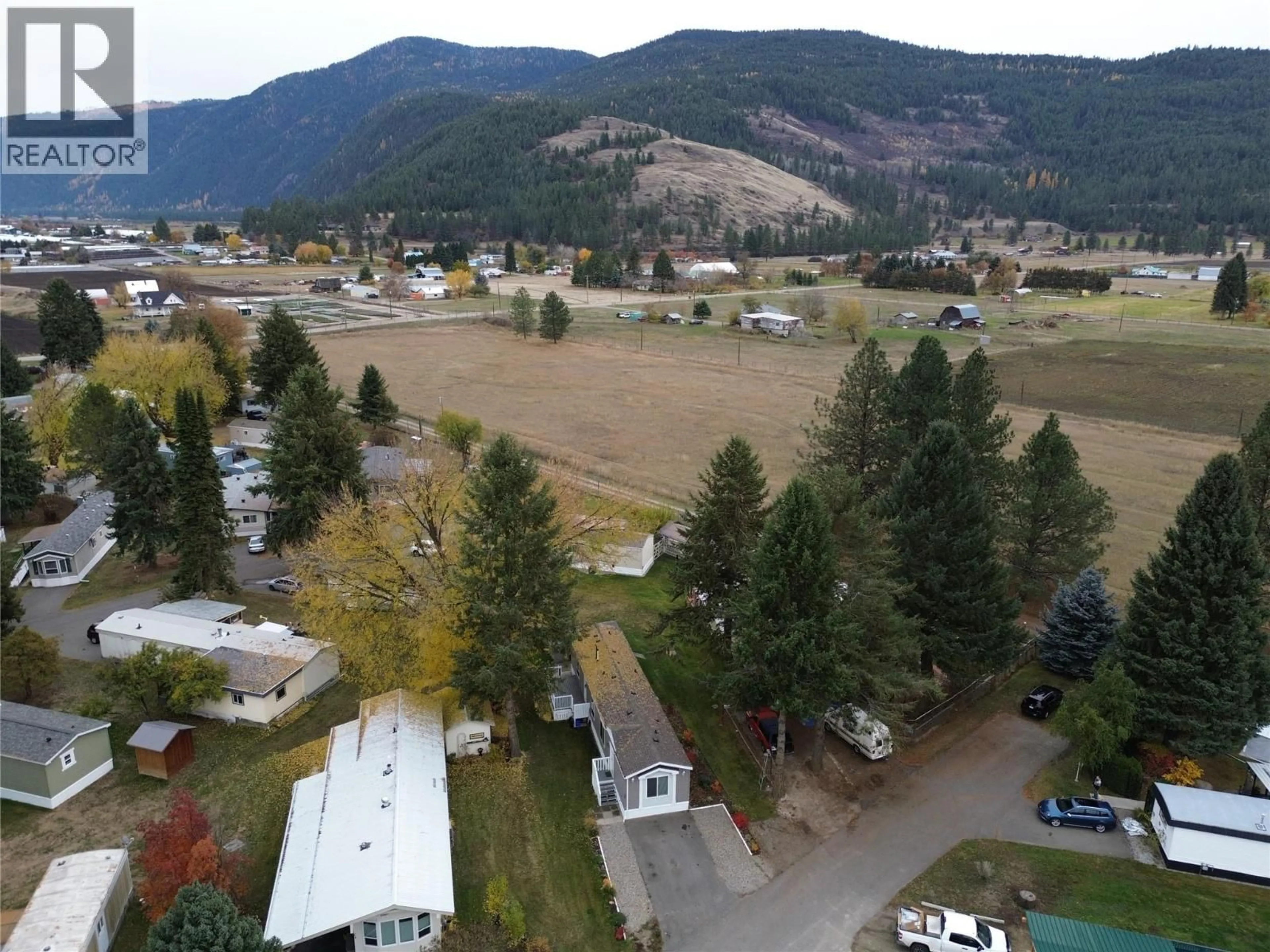 A pic from outside/outdoor area/front of a property/back of a property/a pic from drone, mountain view for C6 - 5455 ALMOND GARDENS ROAD, Grand Forks British Columbia V0H1H4