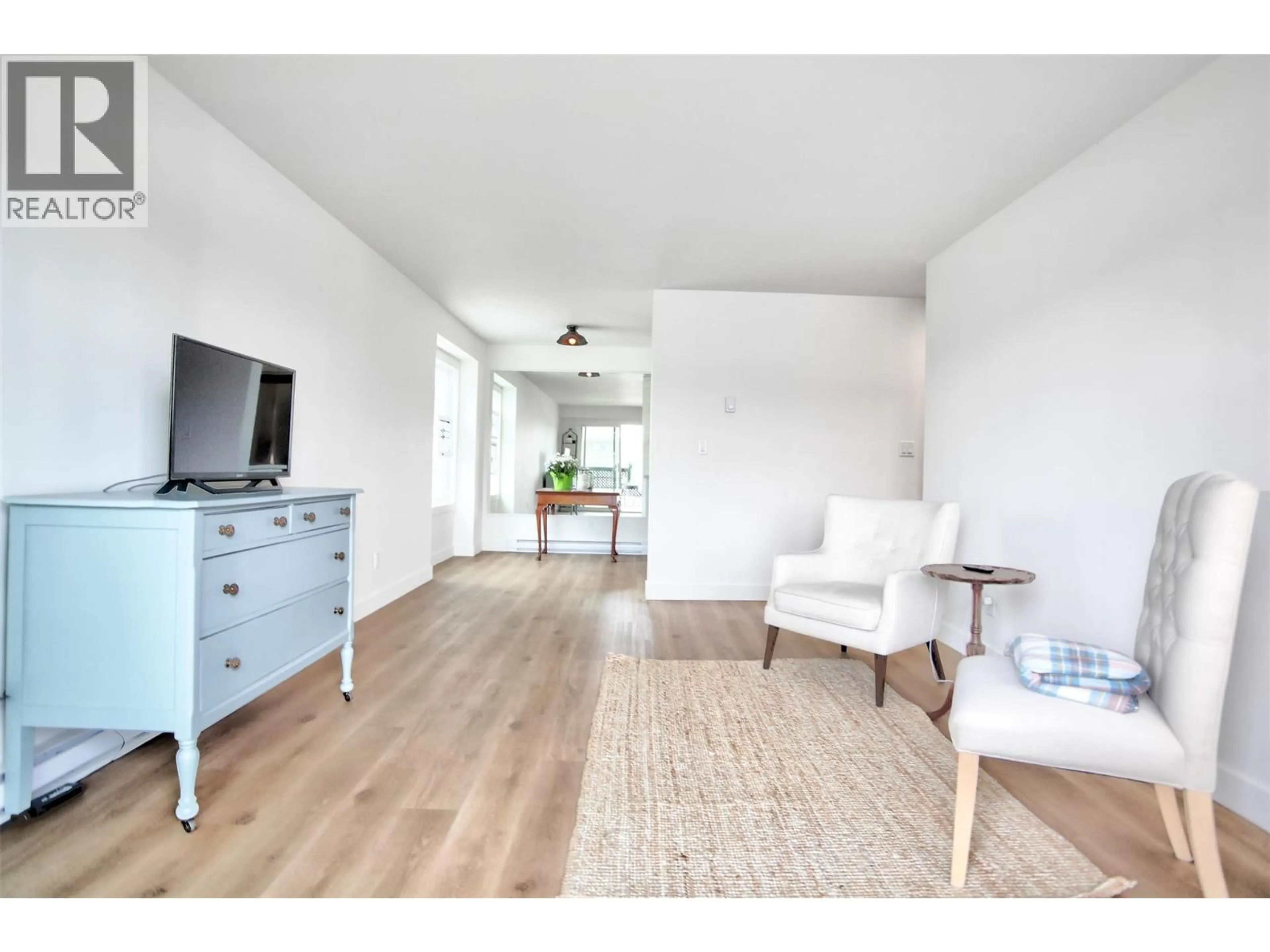 Living room with furniture, wood/laminate floor for 202 - 95 WINNIPEG STREET, Penticton British Columbia V2A5L9