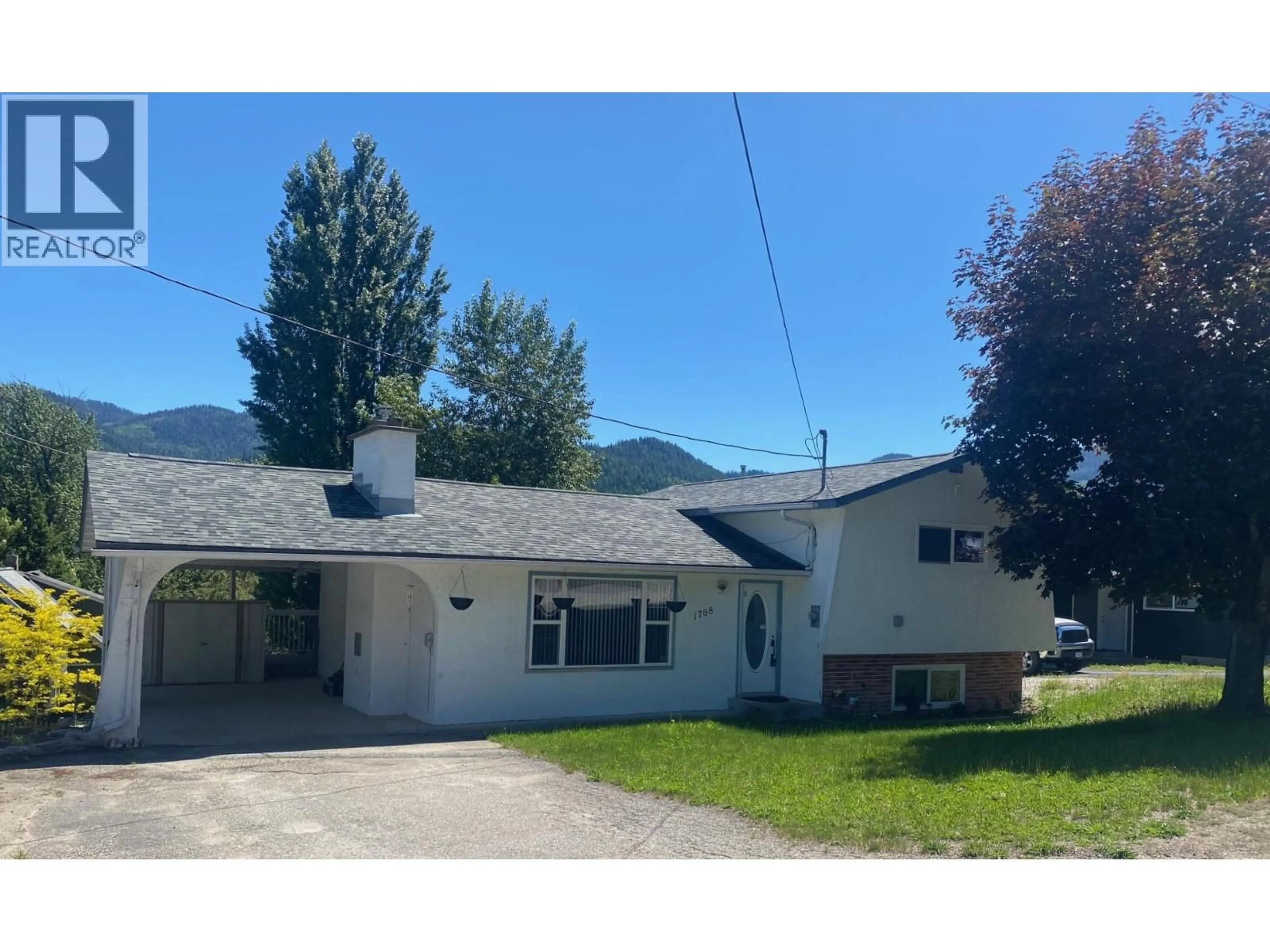 A pic from outside/outdoor area/front of a property/back of a property/a pic from drone, mountain view for 1768 FIRST STREET, Fruitvale British Columbia V0G1L0