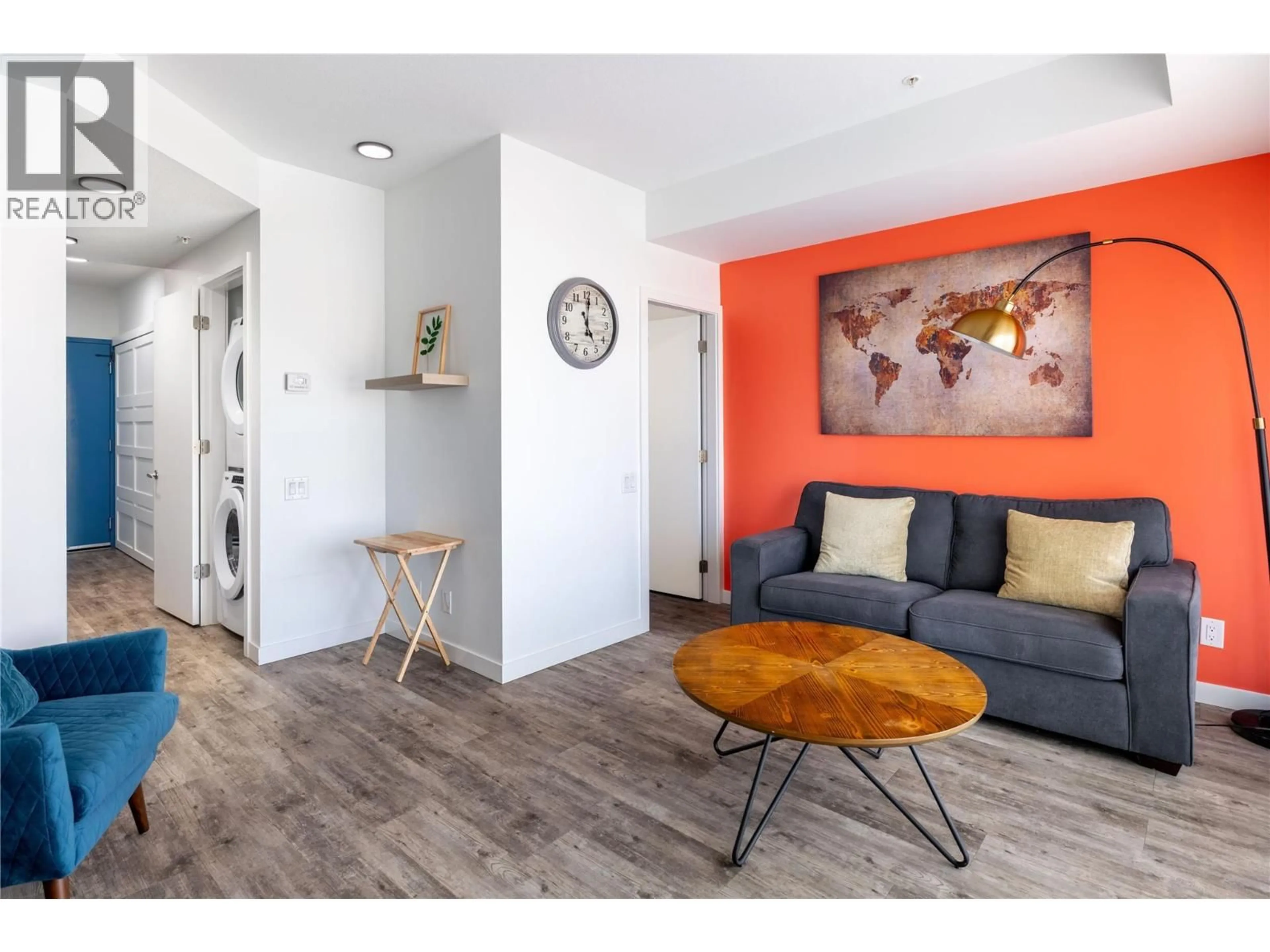 Living room with furniture, wood/laminate floor for 309 - 1083 KLO ROAD, Kelowna British Columbia V1Y4X6