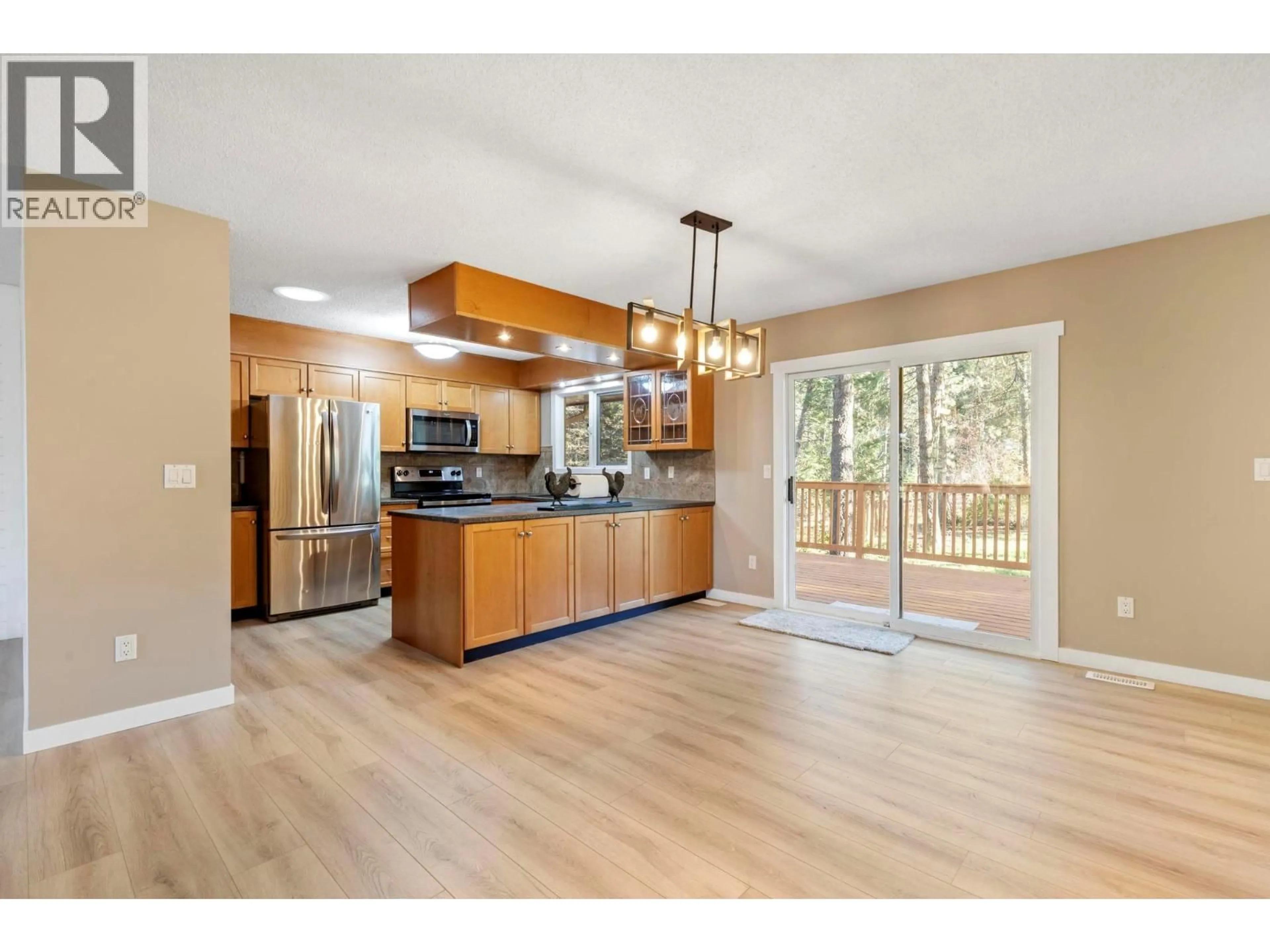 Open concept kitchen, wood/laminate floor for 4019 MILLER ROAD, Kelowna British Columbia V1W4C7