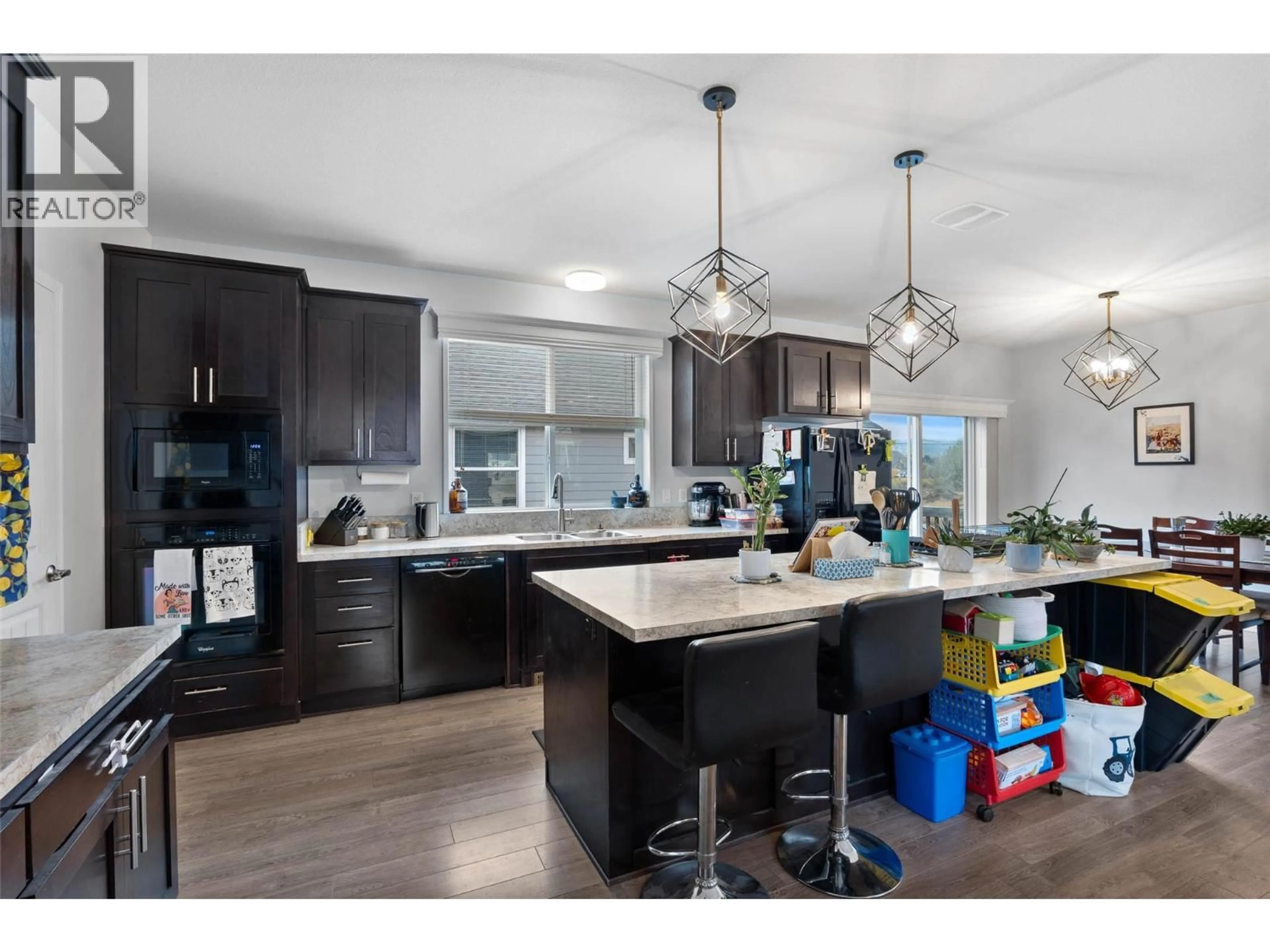 Open concept kitchen, wood/laminate floor for 48 - 712 SHUSWAP E ROAD, Kamloops British Columbia V2H0C8