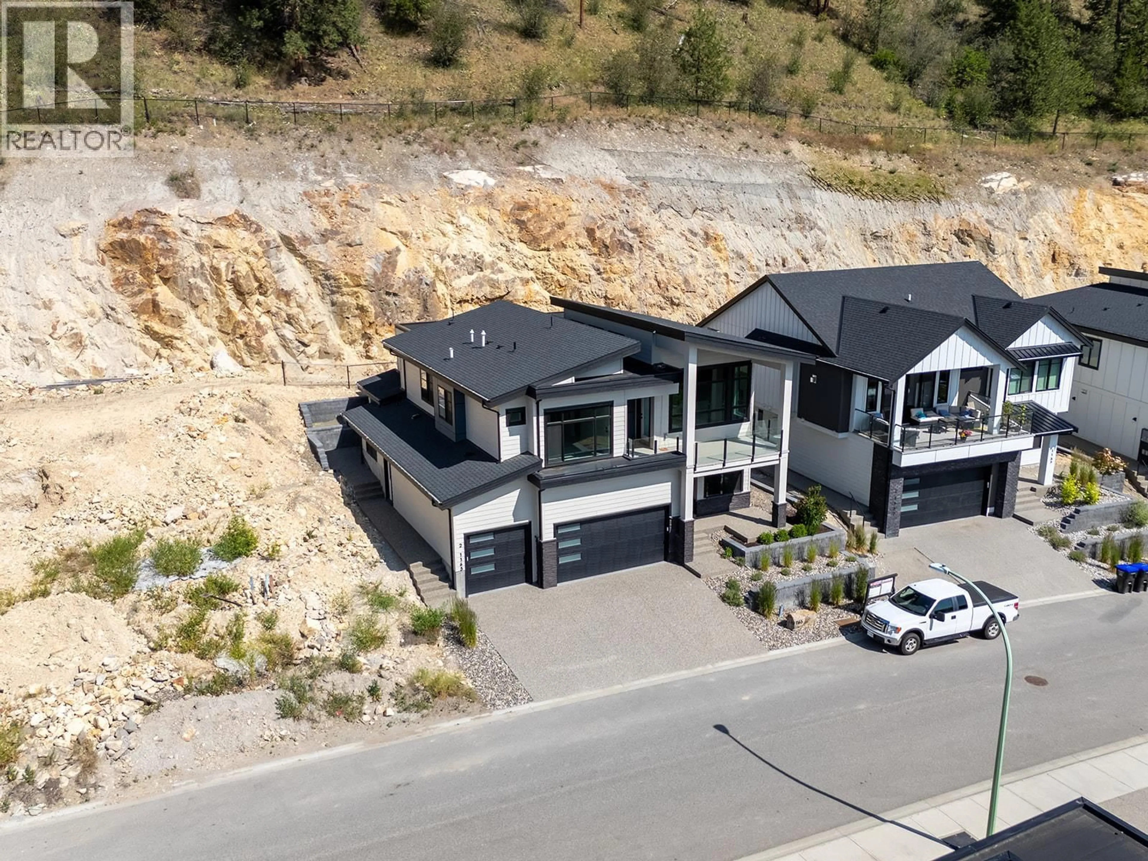 A pic from outside/outdoor area/front of a property/back of a property/a pic from drone, mountain view for 1165 LONE PINE DRIVE, Kelowna British Columbia V1P0A5
