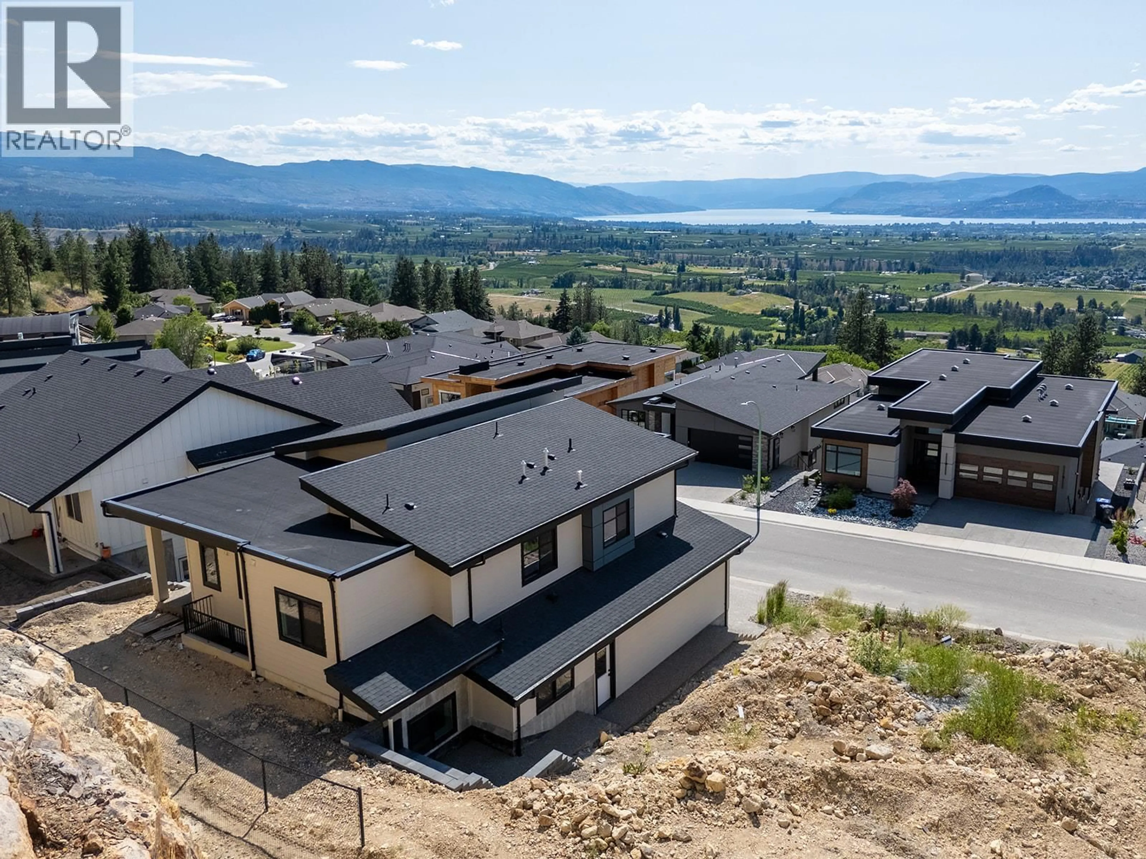 A pic from outside/outdoor area/front of a property/back of a property/a pic from drone, mountain view for 1165 LONE PINE DRIVE, Kelowna British Columbia V1P0A5