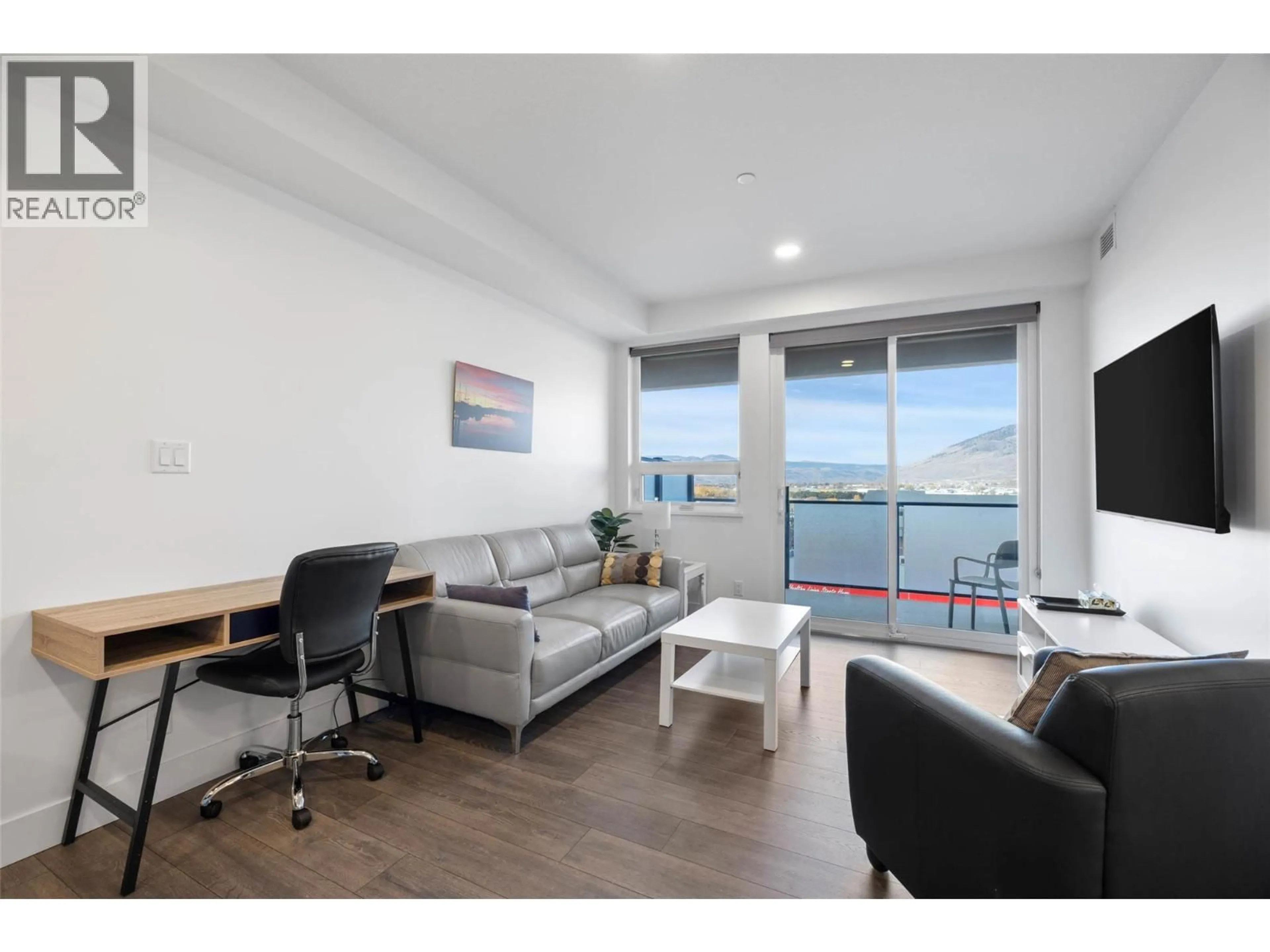 Living room with furniture, wood/laminate floor for 518 - 444 ST PAUL STREET, Kamloops British Columbia V2C2J6