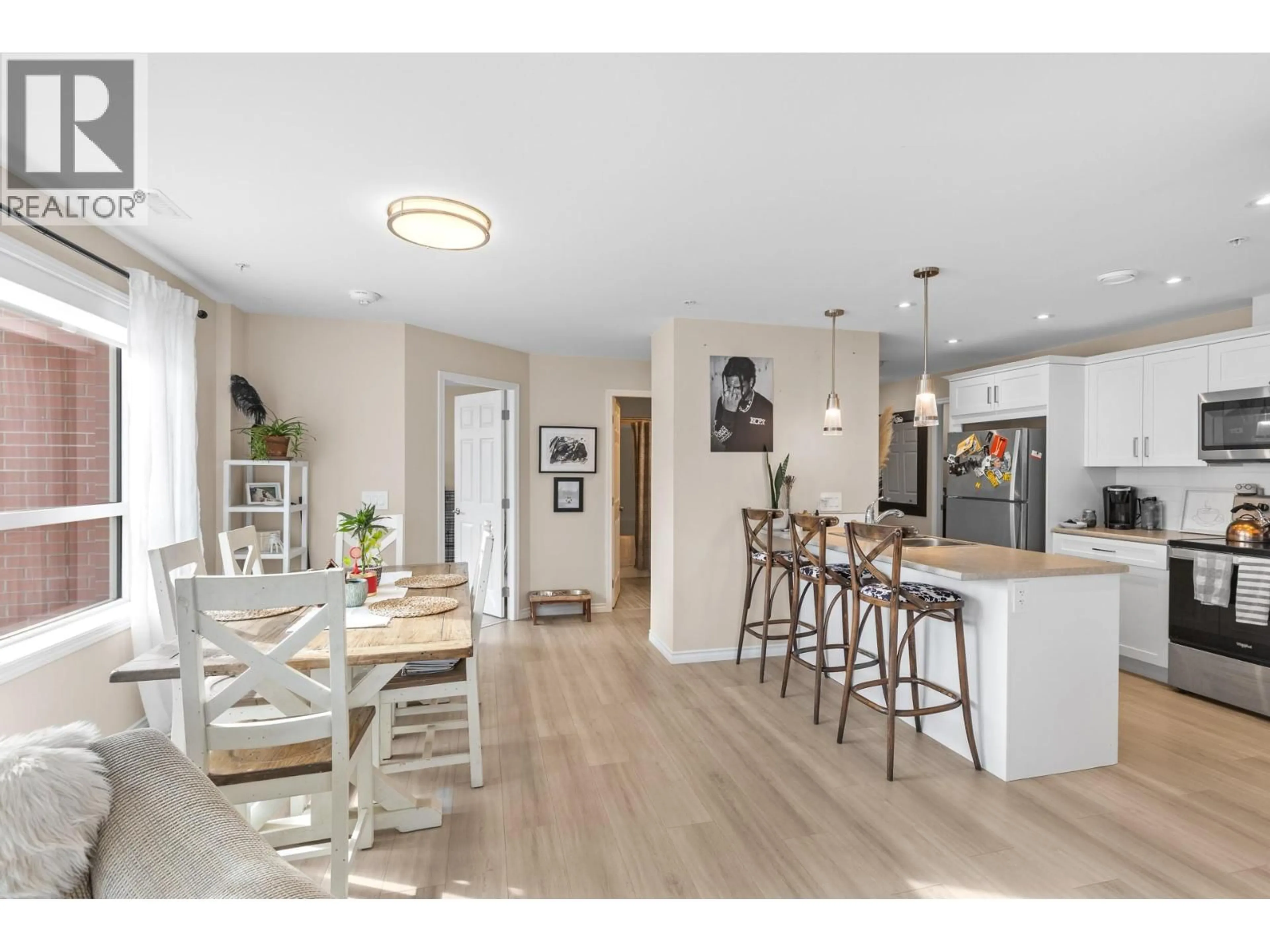 Open concept kitchen, wood/laminate floor for 307 - 3362 SKAHA LAKE ROAD, Penticton British Columbia V2A6G4
