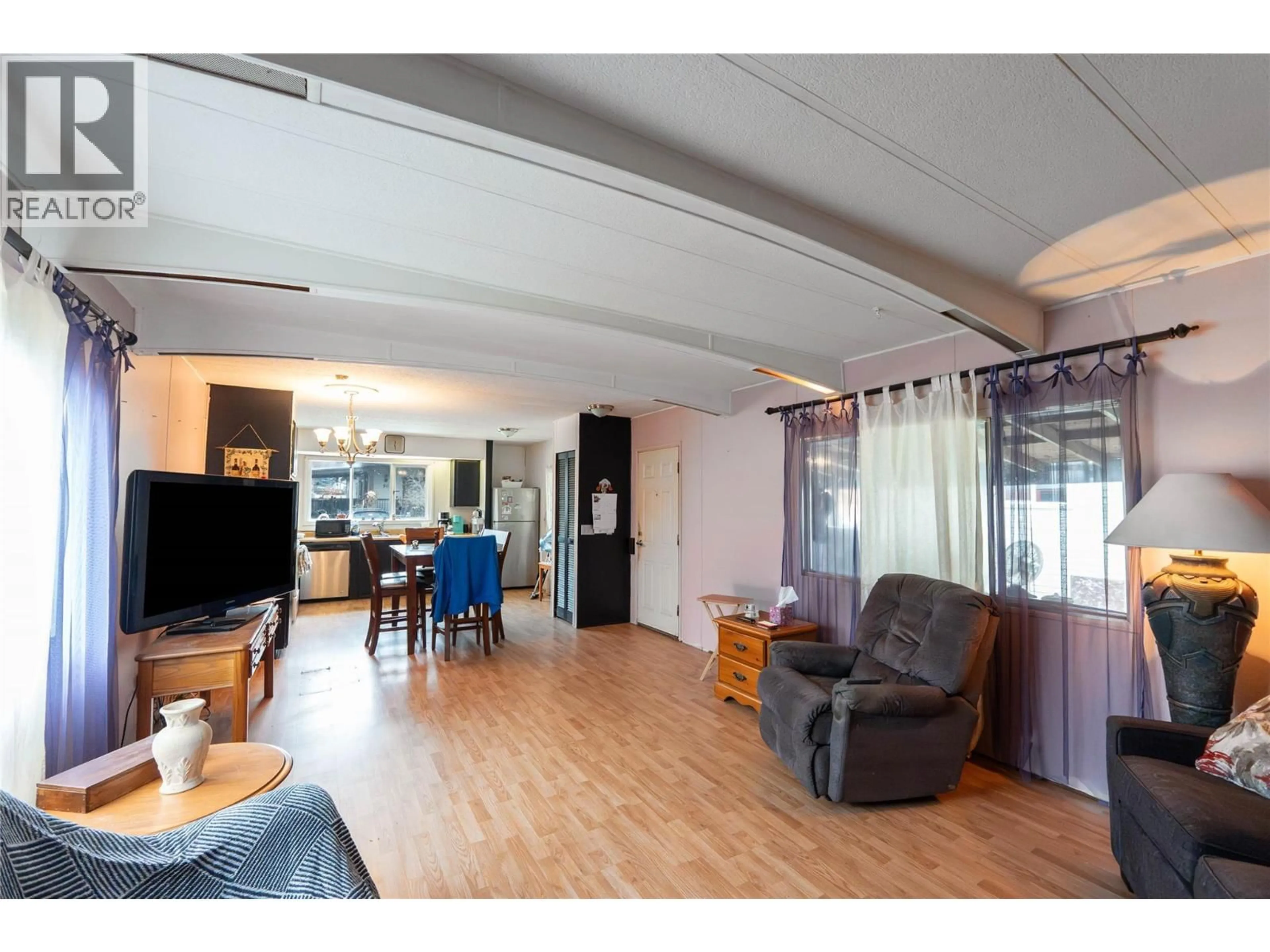 Living room with furniture, wood/laminate floor for 40 - 720 COMMONWEALTH ROAD, Kelowna British Columbia V4V1R6