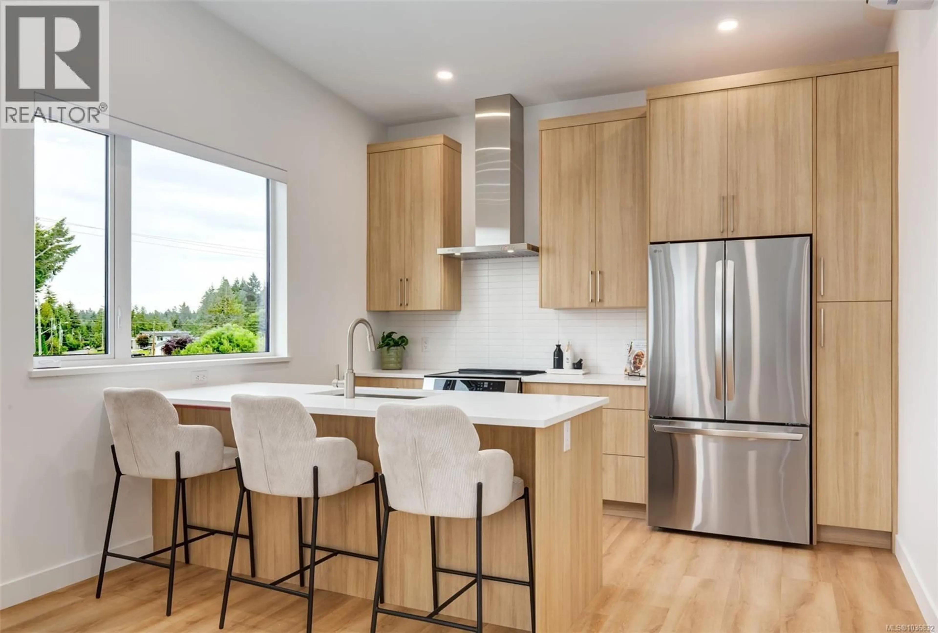 Open concept kitchen, wood/laminate floor for 202 - 7181 LANTZVILLE ROAD, Lantzville British Columbia V0R2H0