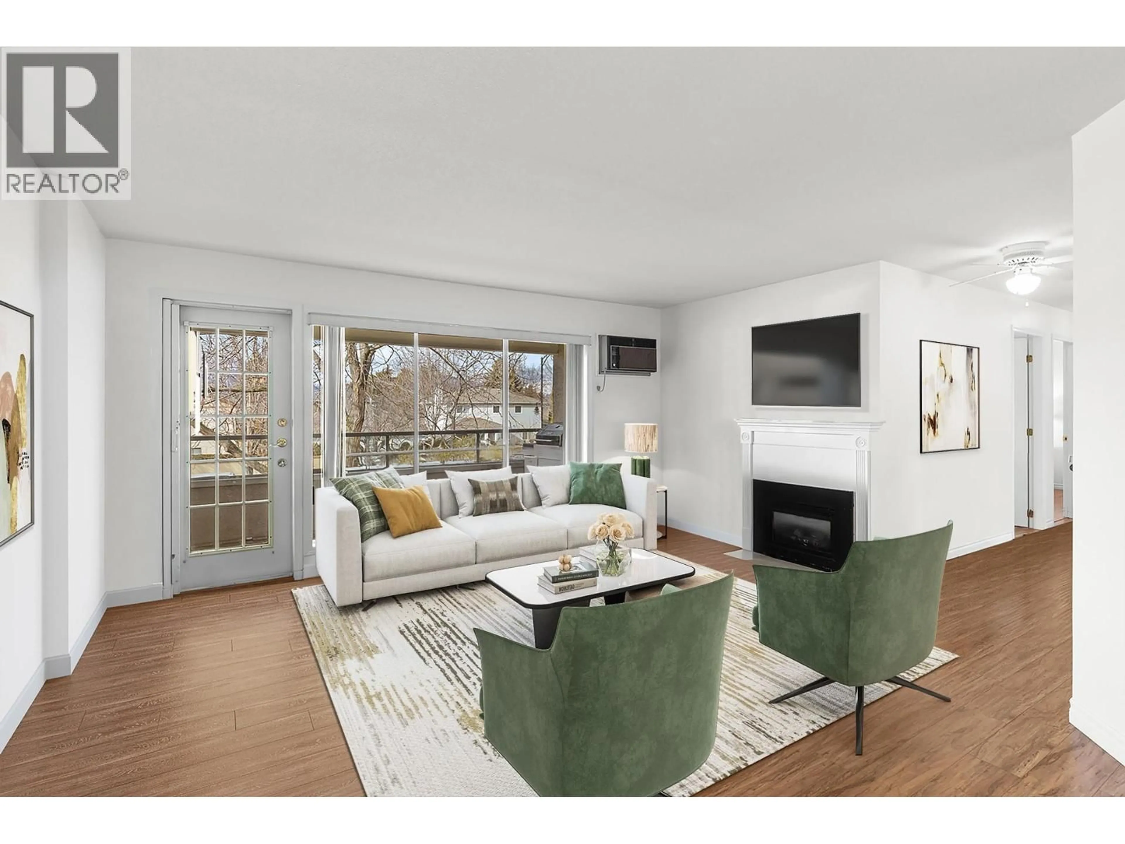 Living room with furniture, wood/laminate floor for 205 - 645 BARRERA ROAD, Kelowna British Columbia V1W3C9