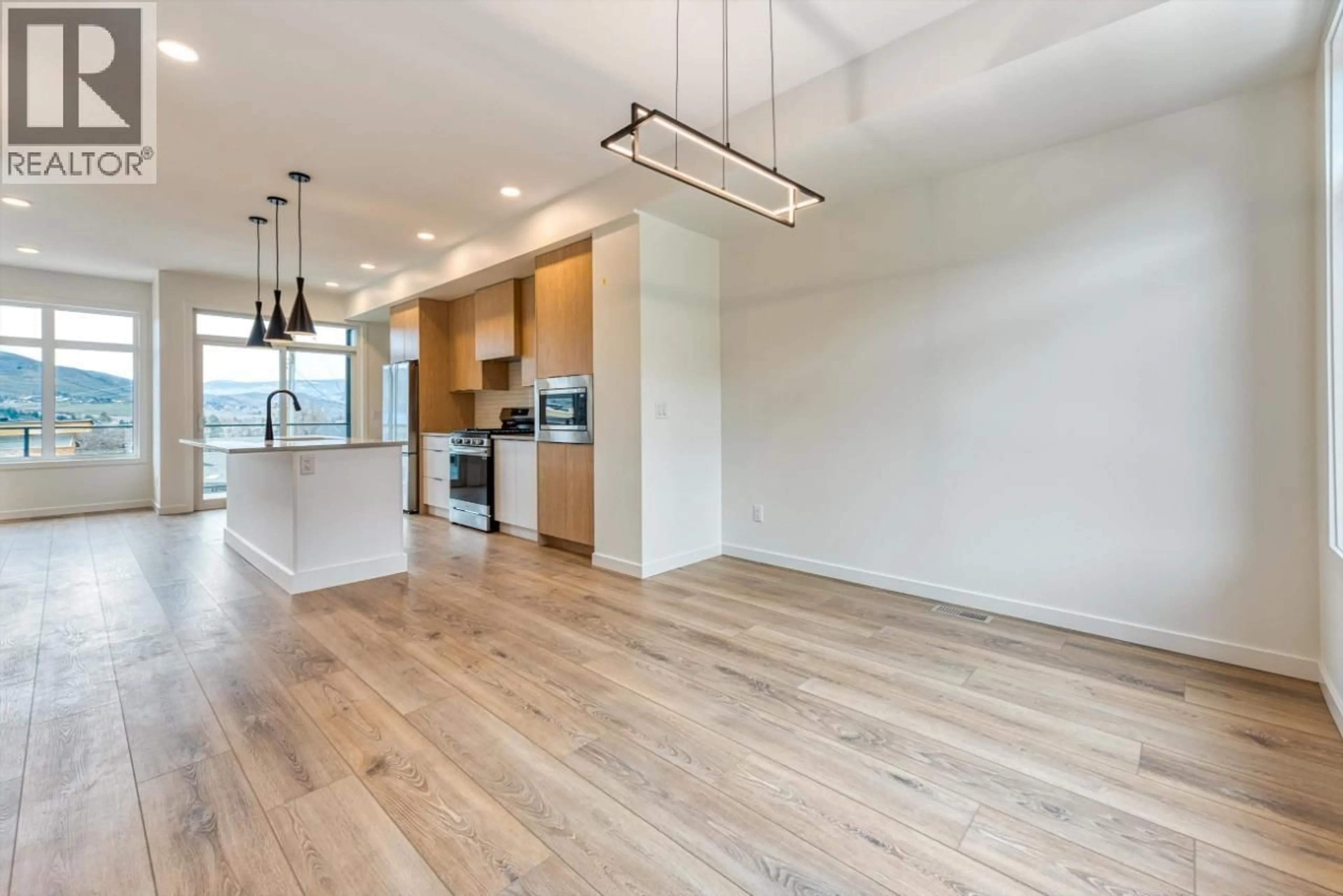 Open concept kitchen, wood/laminate floor for 2 - 7599 KLINGER ROAD, Vernon British Columbia V1H1G9