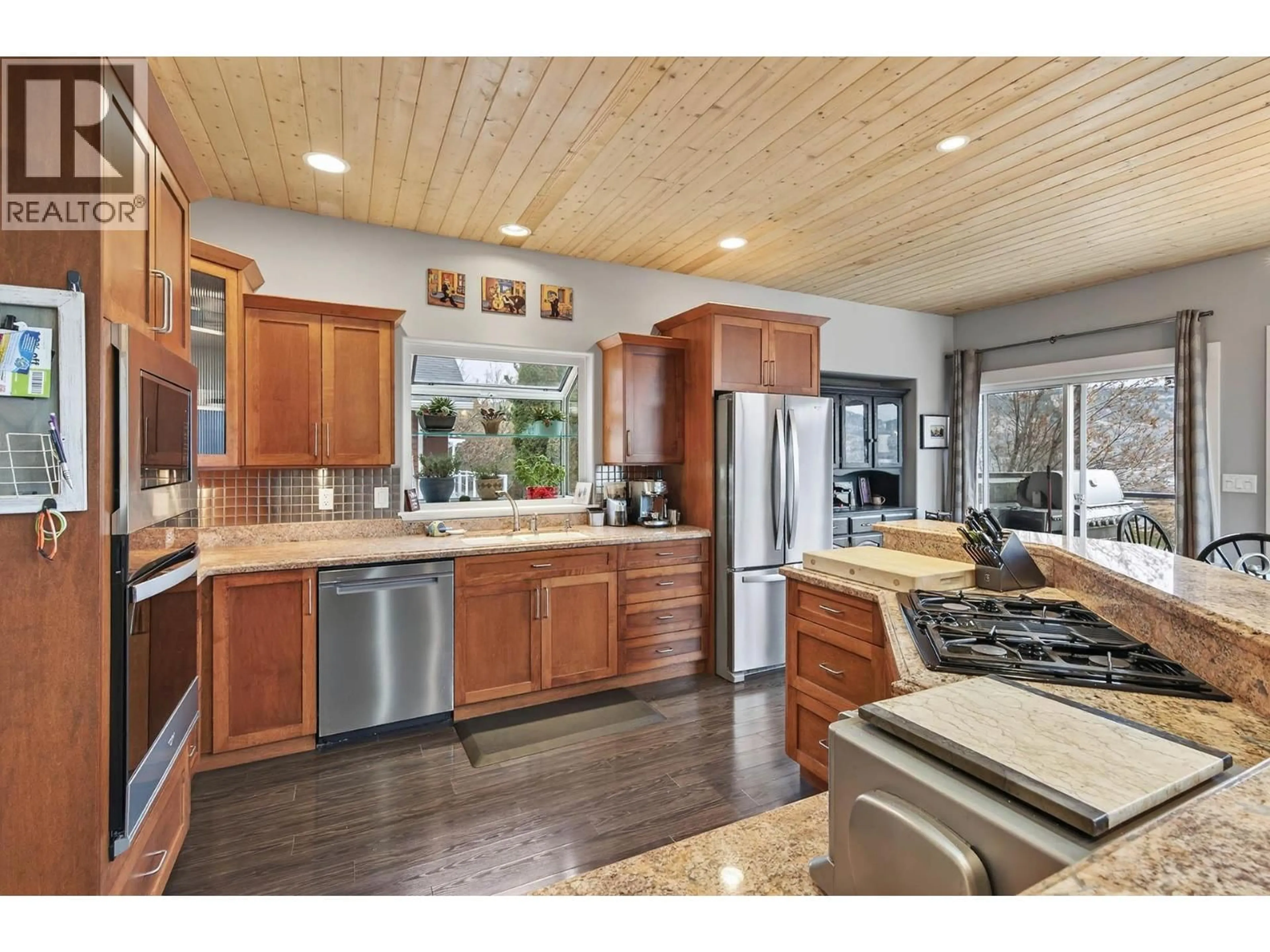 Open concept kitchen, wood/laminate floor for 302 MARIPOSA COURT, Kamloops British Columbia V2H1R3