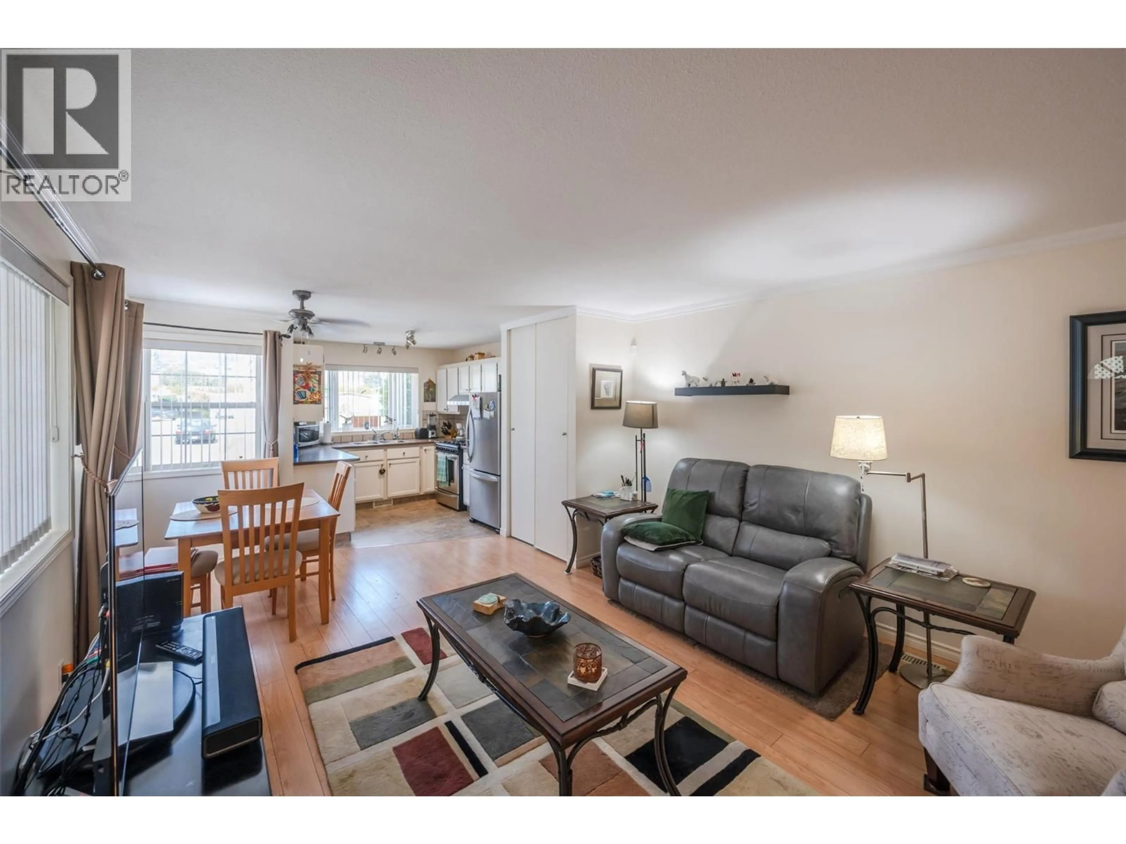 Living room with furniture, wood/laminate floor for 54 - 999 BURNABY AVENUE, Penticton British Columbia V2A1G7