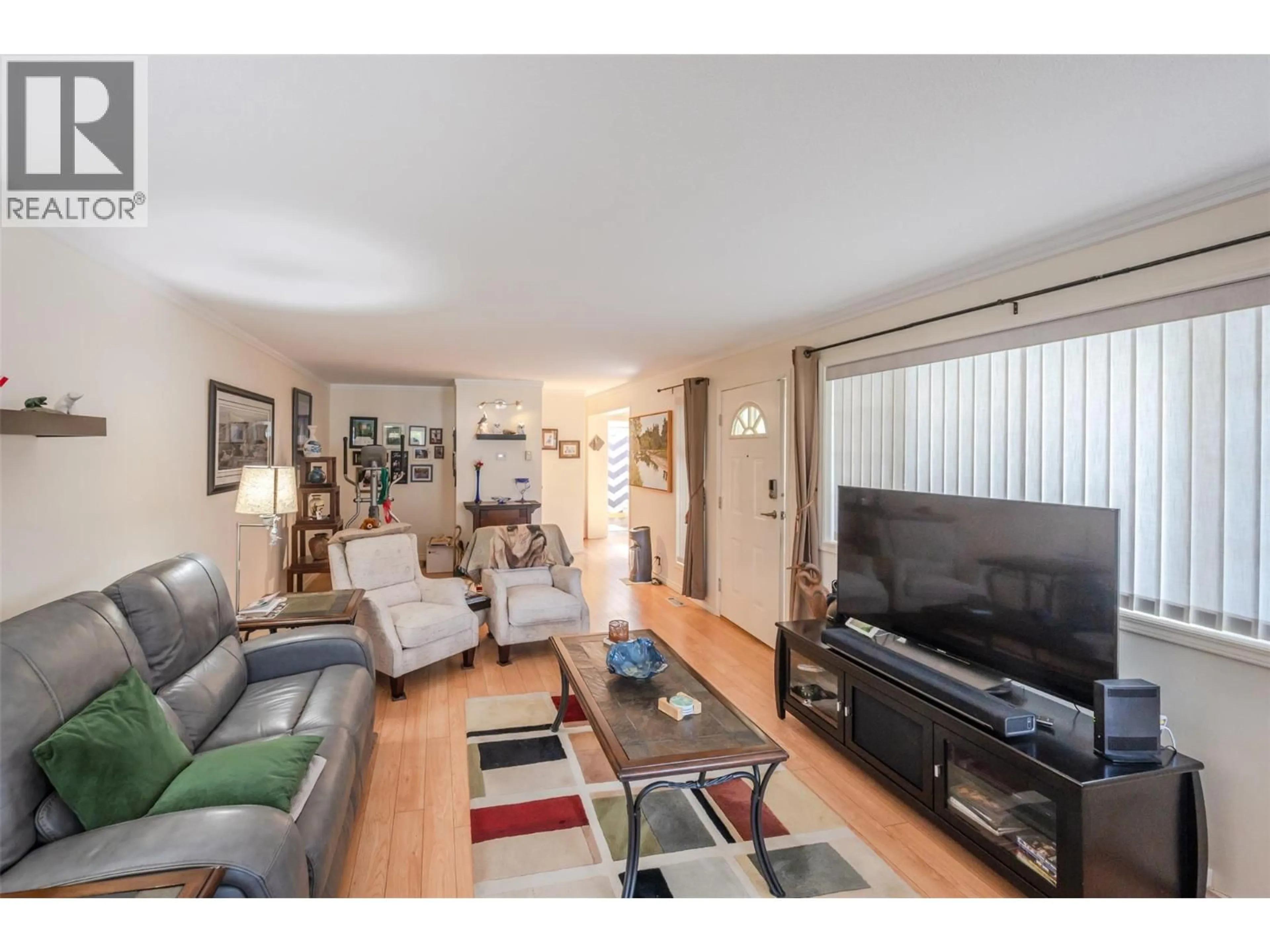 Living room with furniture, wood/laminate floor for 54 - 999 BURNABY AVENUE, Penticton British Columbia V2A1G7