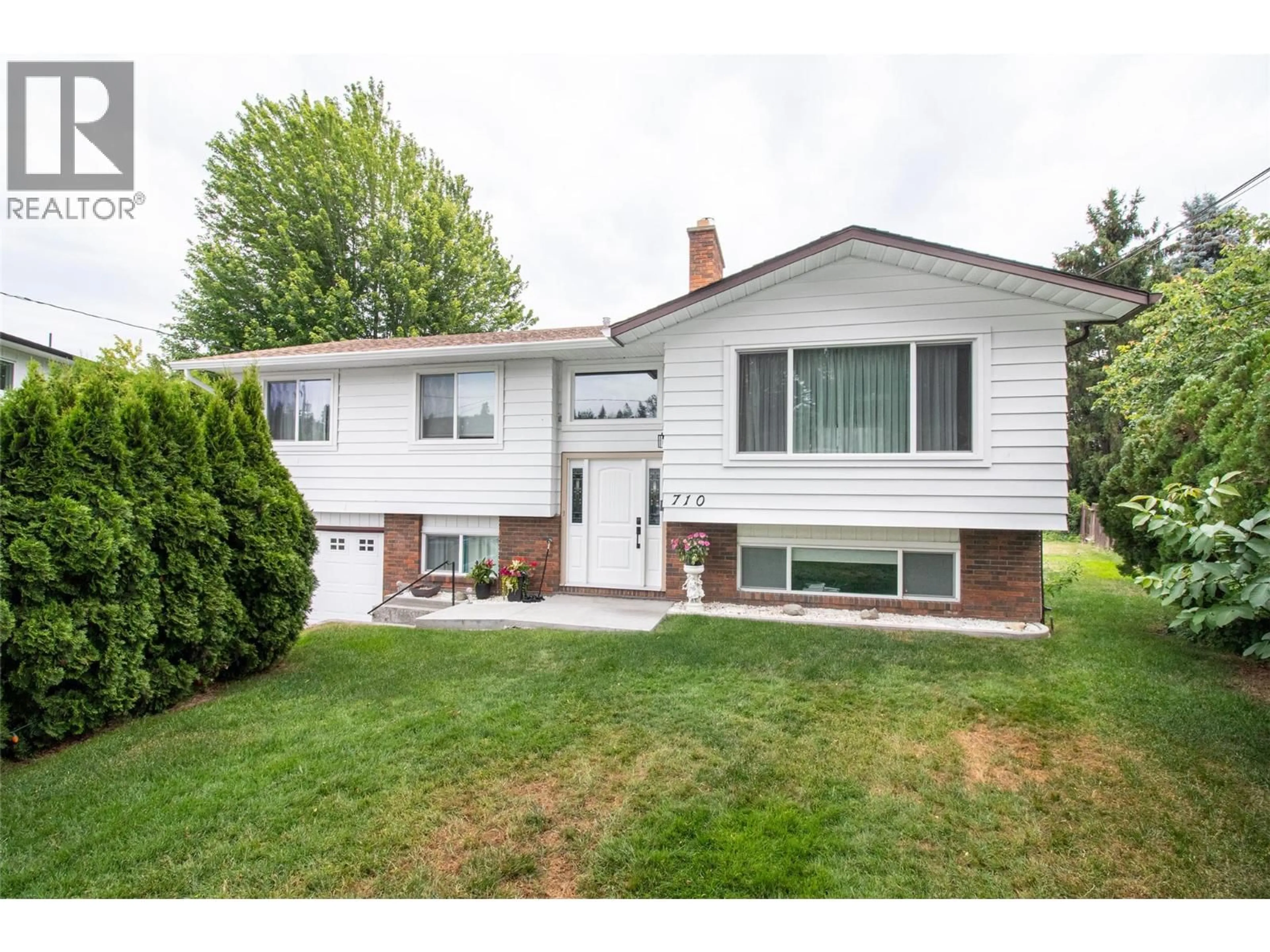 Home with vinyl exterior material, street for 710 TAMARACK DRIVE, Kelowna British Columbia V1X5L9