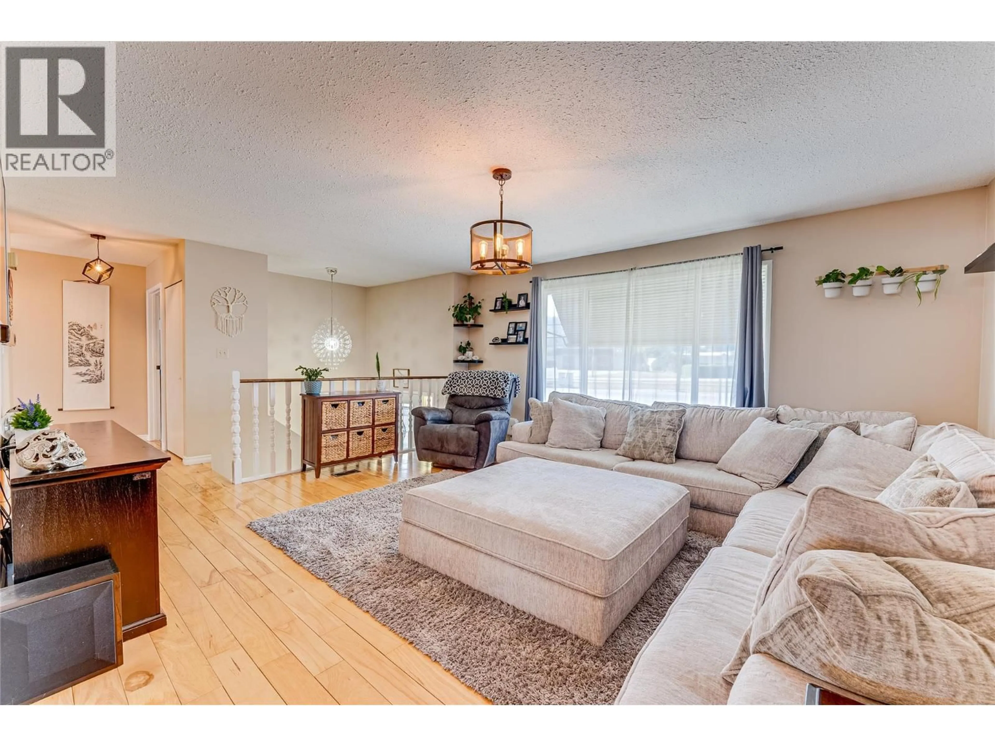 Living room with furniture, wood/laminate floor for 101 CRESCENT DRIVE, Enderby British Columbia V0E1V2