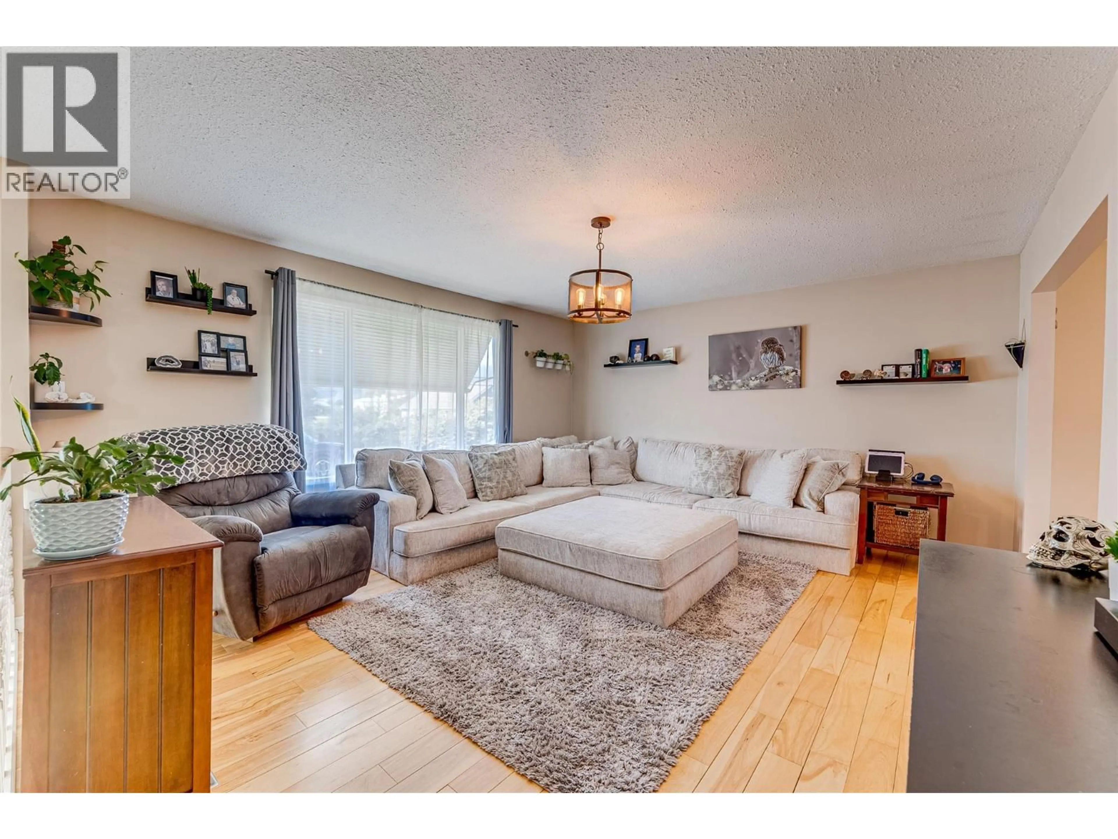 Living room with furniture, wood/laminate floor for 101 CRESCENT DRIVE, Enderby British Columbia V0E1V2