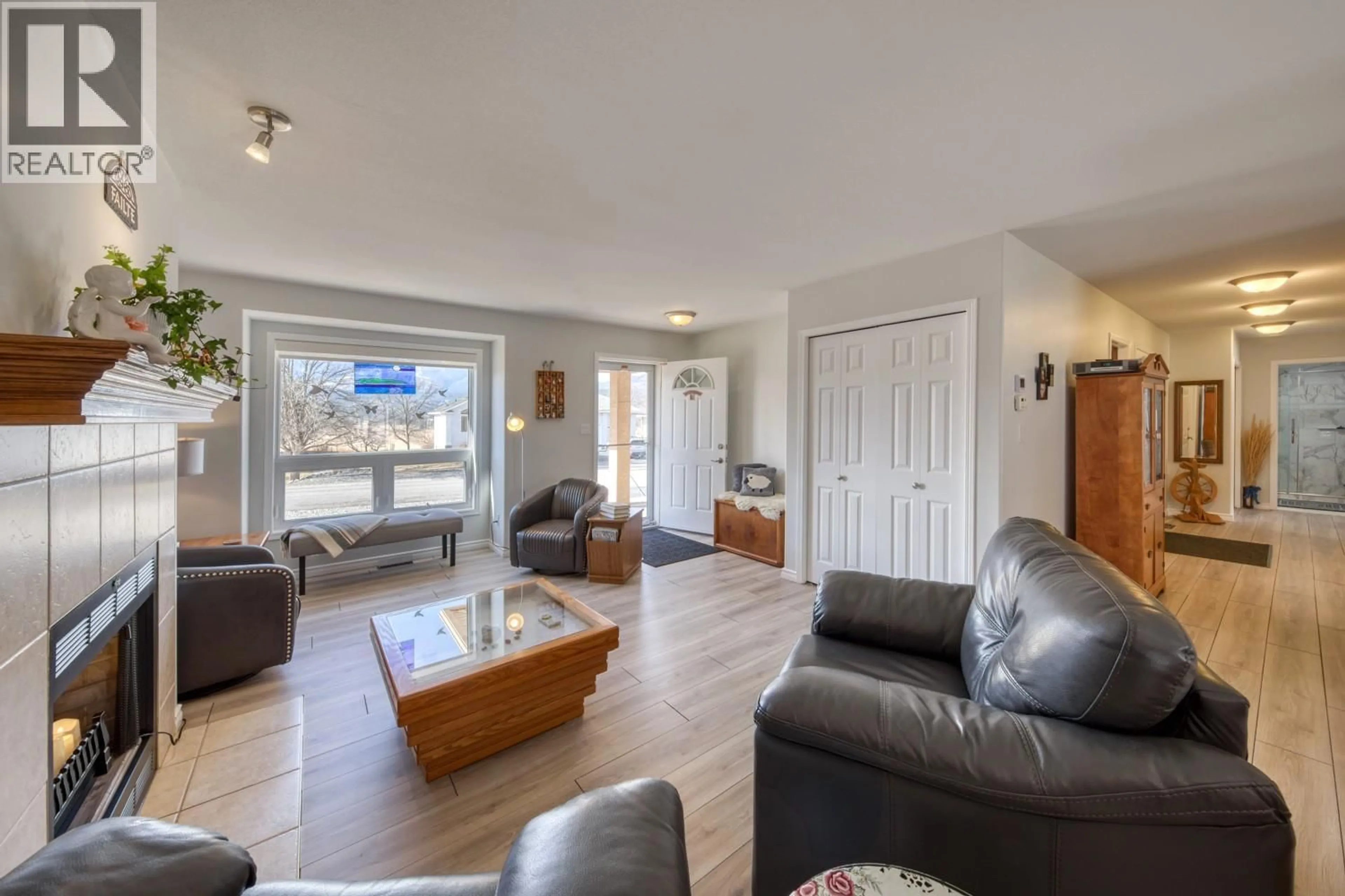 Living room with furniture, wood/laminate floor for 4887 GLEN EAGLE DRIVE, Fairmont Hot Springs British Columbia V0B1L1
