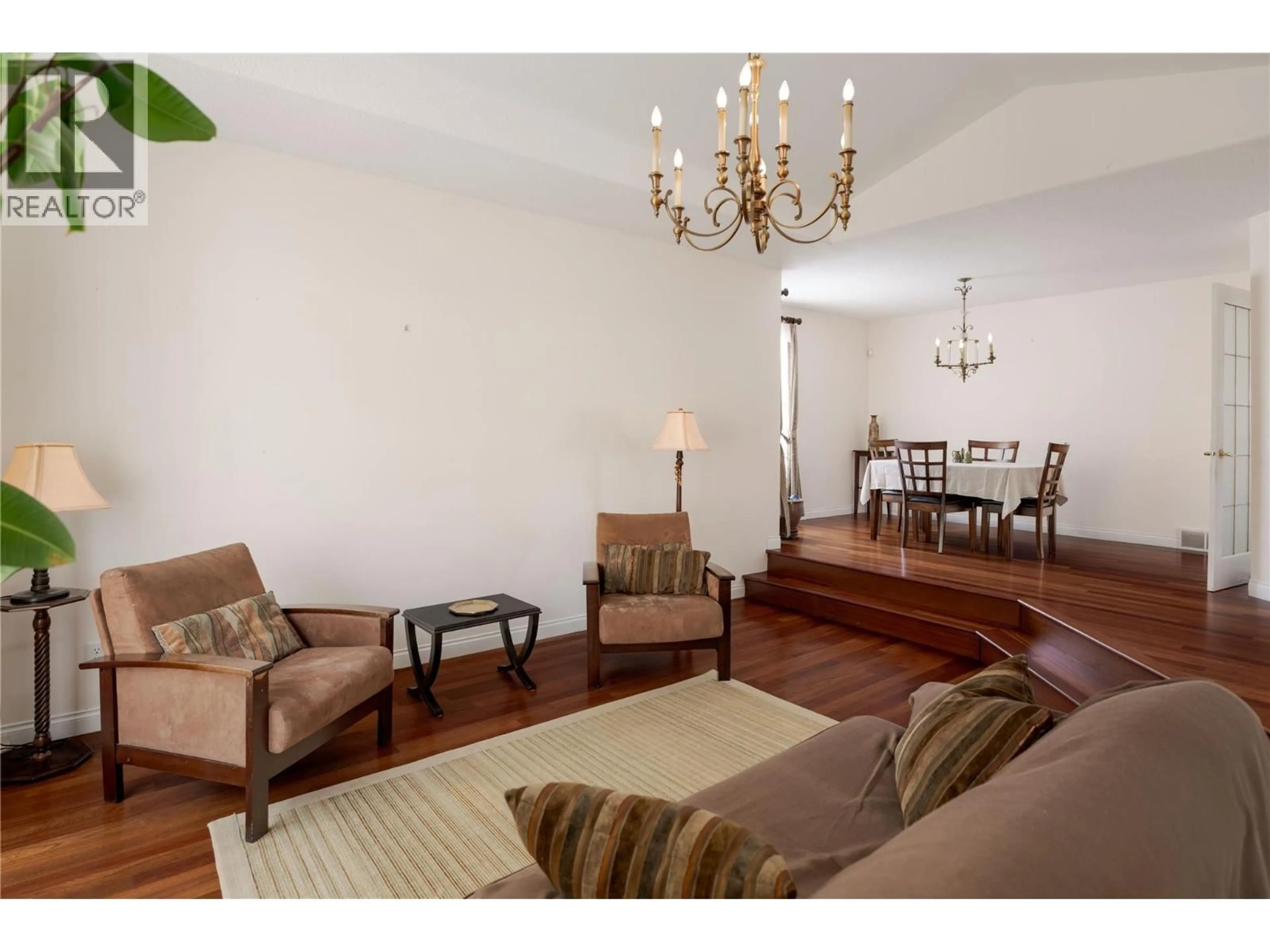 Living room with furniture, wood/laminate floor for 740 ROYAL PINE DRIVE, Kelowna British Columbia V1Y9G2