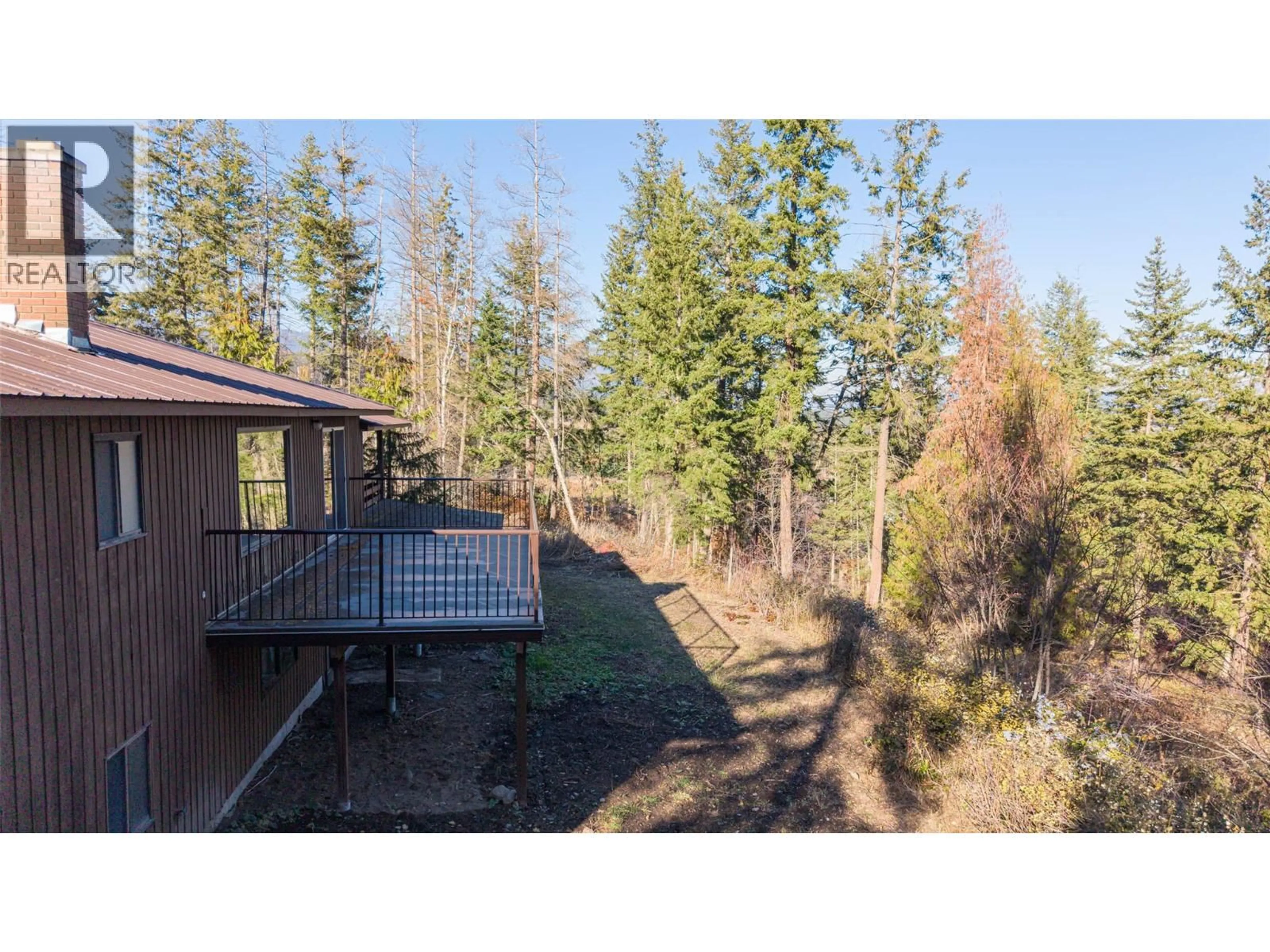 A pic from outside/outdoor area/front of a property/back of a property/a pic from drone, forest/trees view for 4358 CHAMBERLAIN ROAD, Spallumcheen British Columbia V4Y0M1