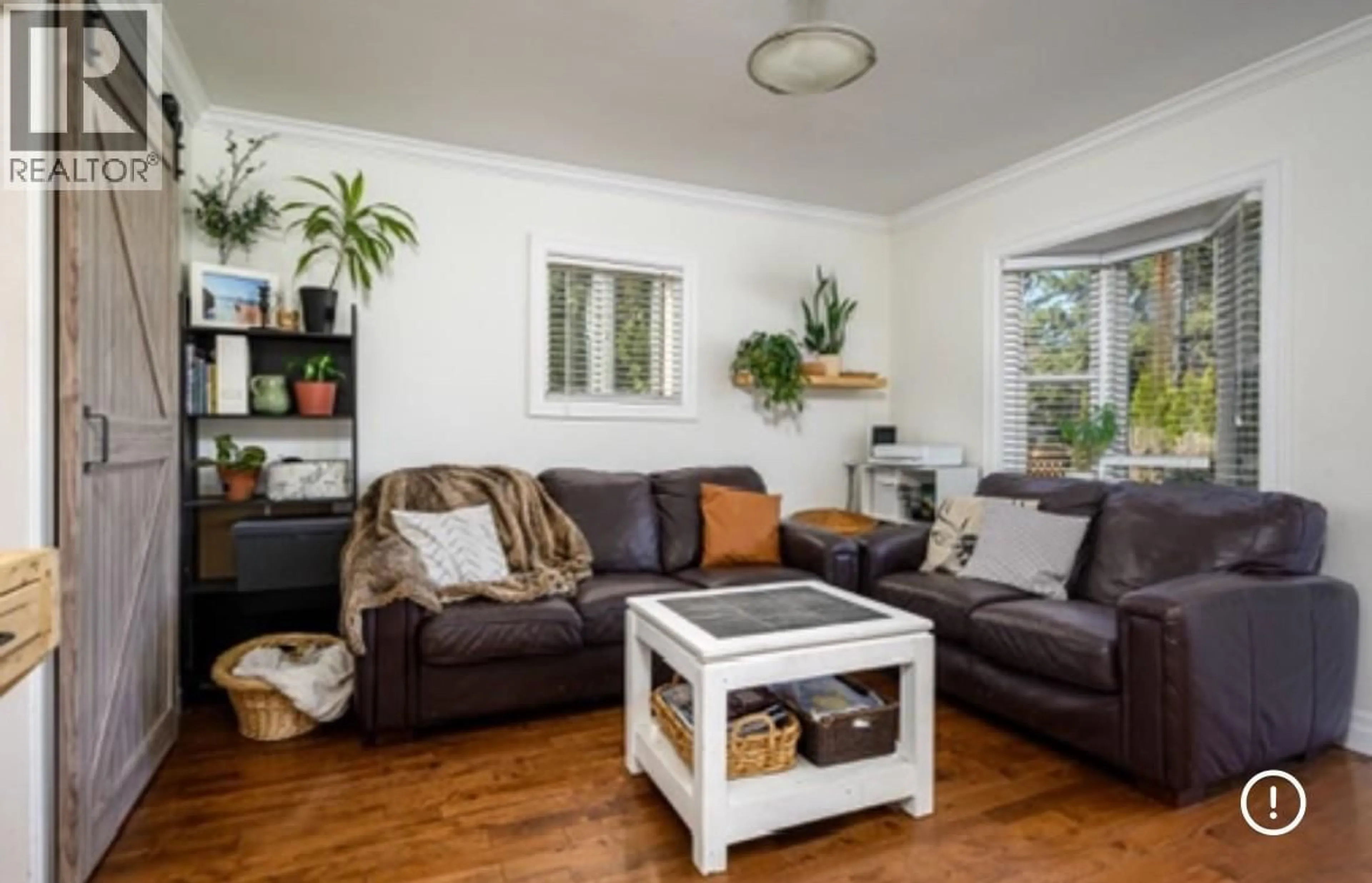 Living room with furniture, wood/laminate floor for 4005 24 STREET, Vernon British Columbia V1T4N7
