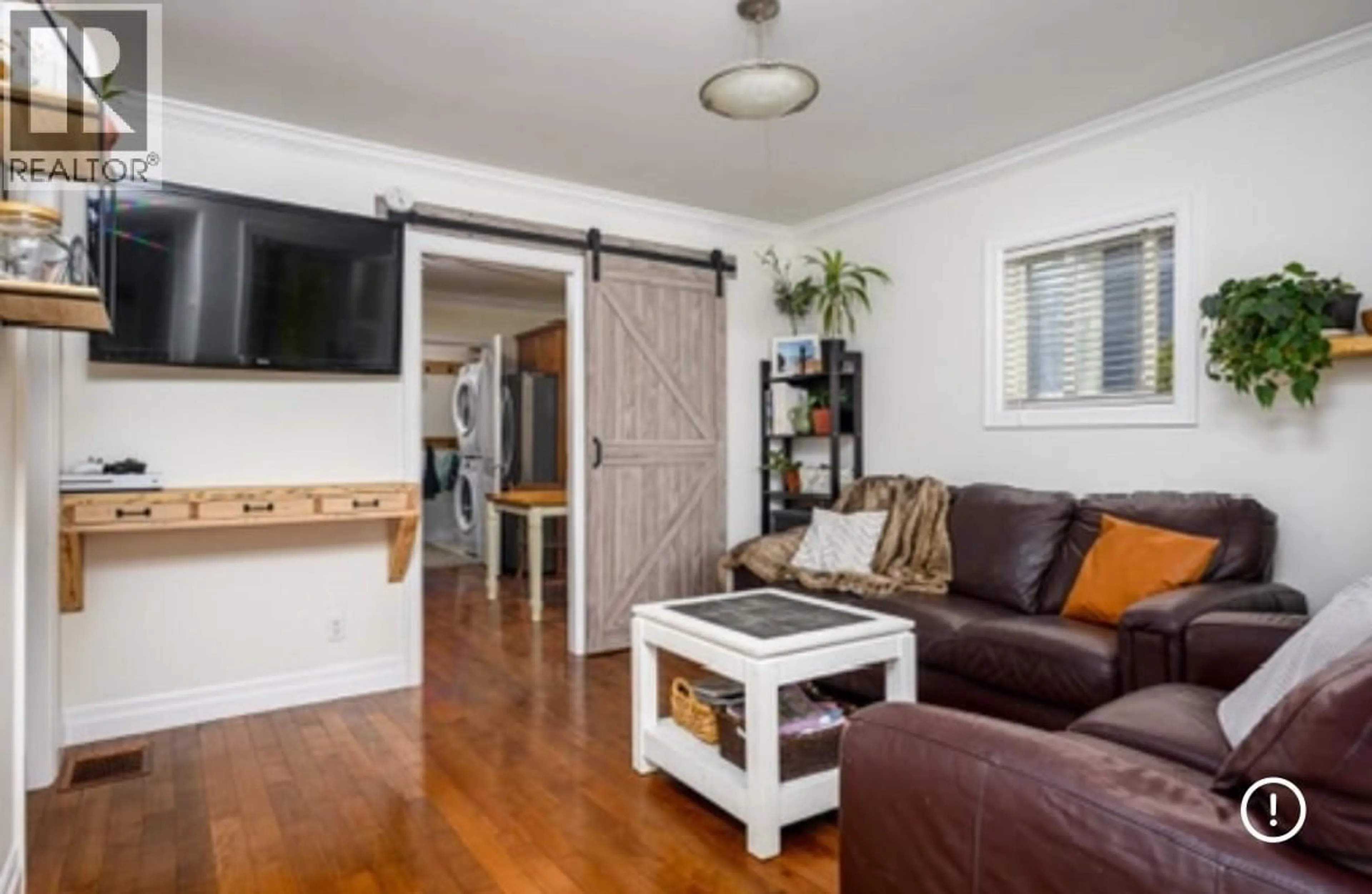 Living room with furniture, wood/laminate floor for 4005 24 STREET, Vernon British Columbia V1T4N7