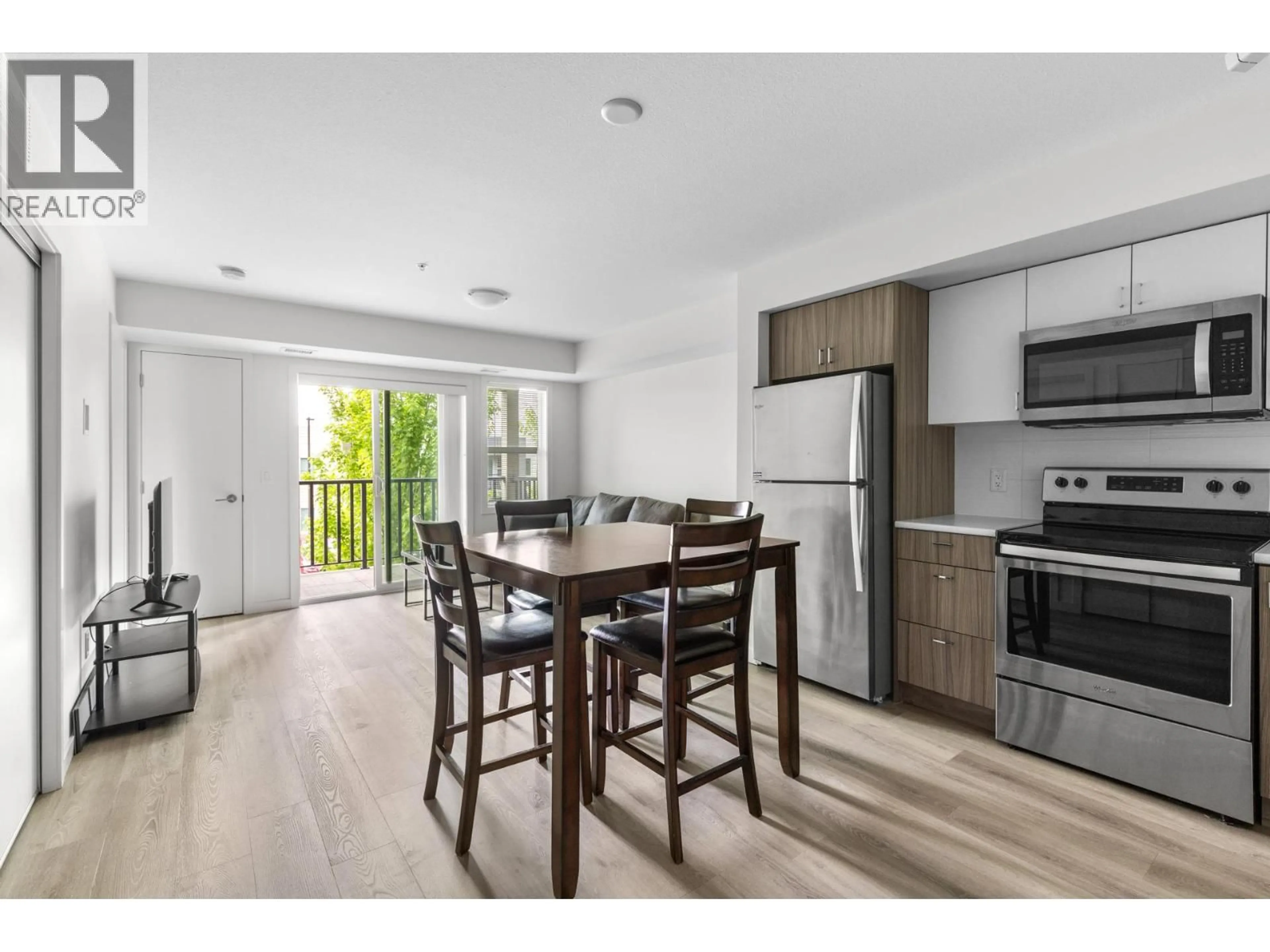 Open concept kitchen, wood/laminate floor for 105 - 695 ACADEMY WAY, Kelowna British Columbia V1V0C7