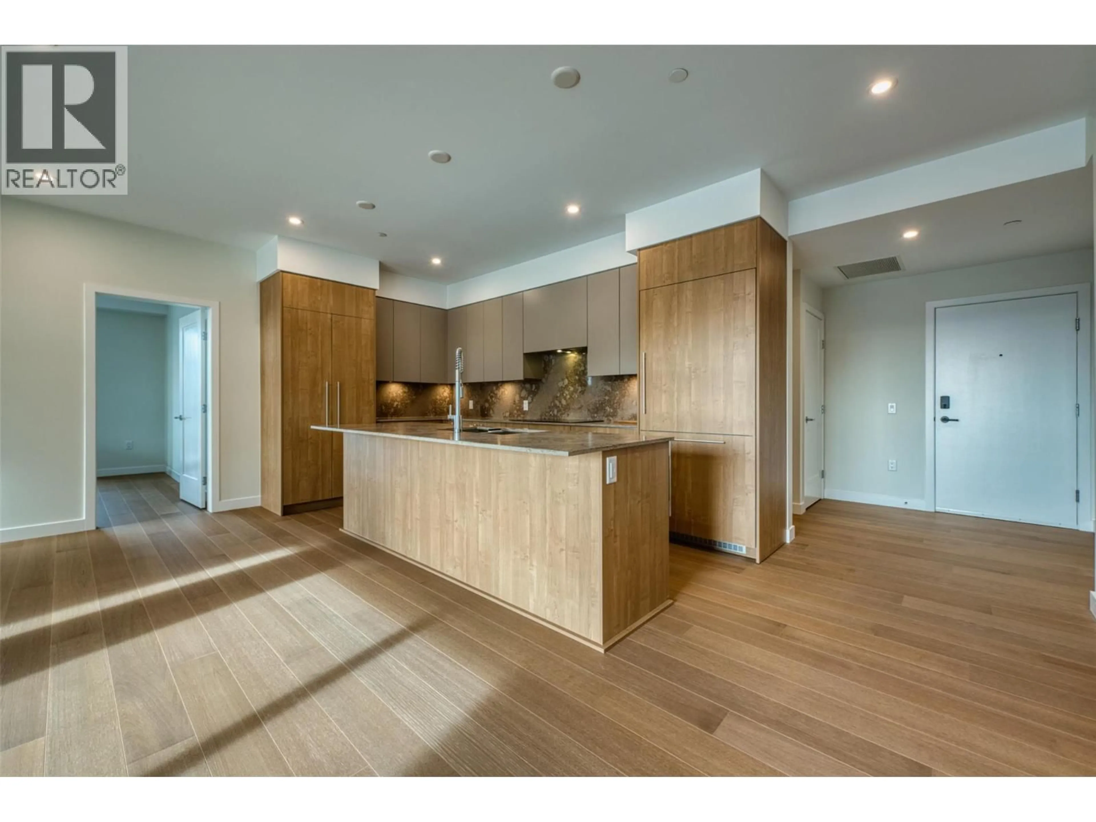 Open concept kitchen, wood/laminate floor for 205 - 9652 BENCHLAND DRIVE, Lake Country British Columbia V4V0C4