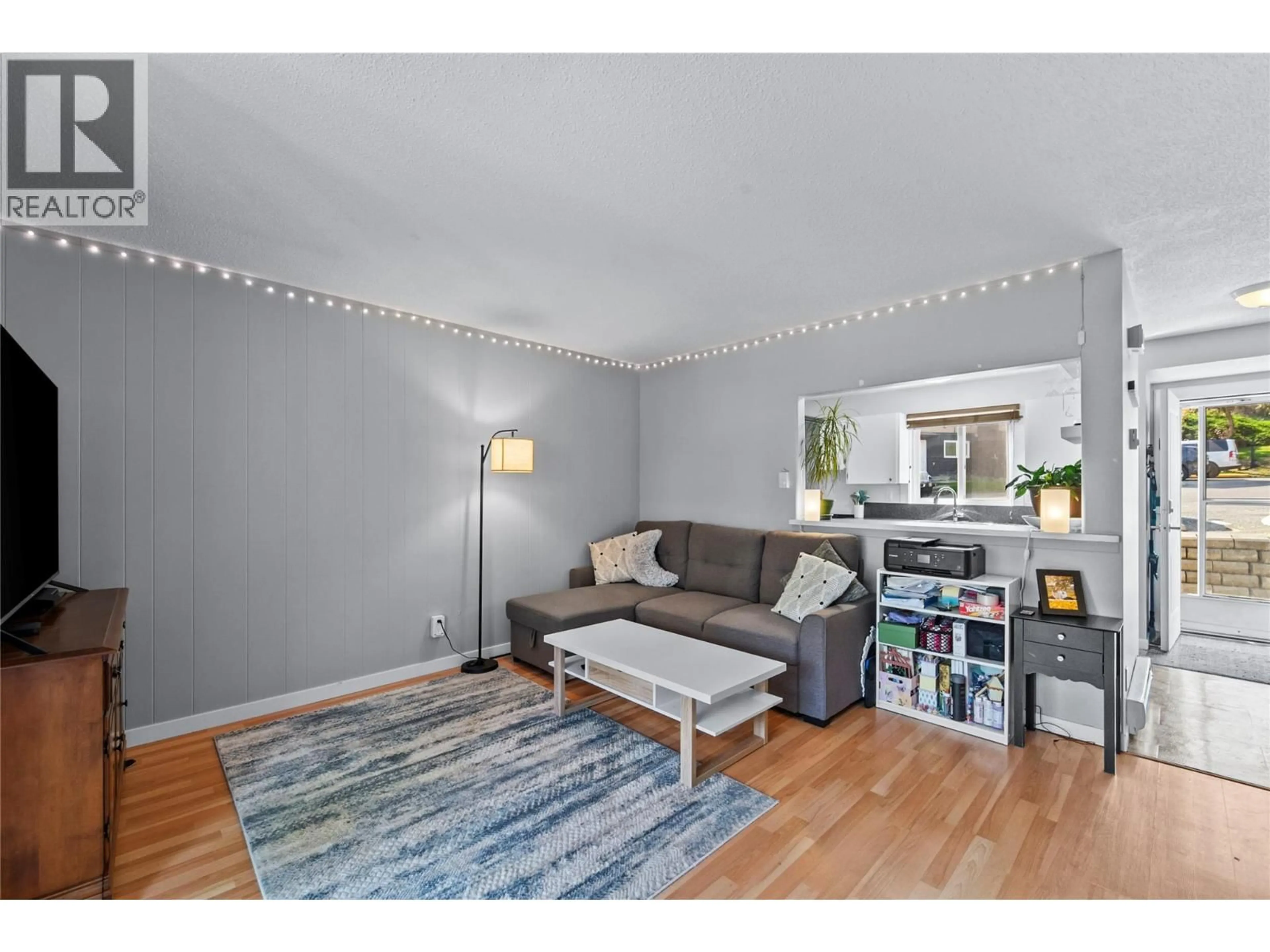 Living room with furniture, wood/laminate floor for 57 - 1605 SUMMIT DRIVE, Kamloops British Columbia V2E2A5