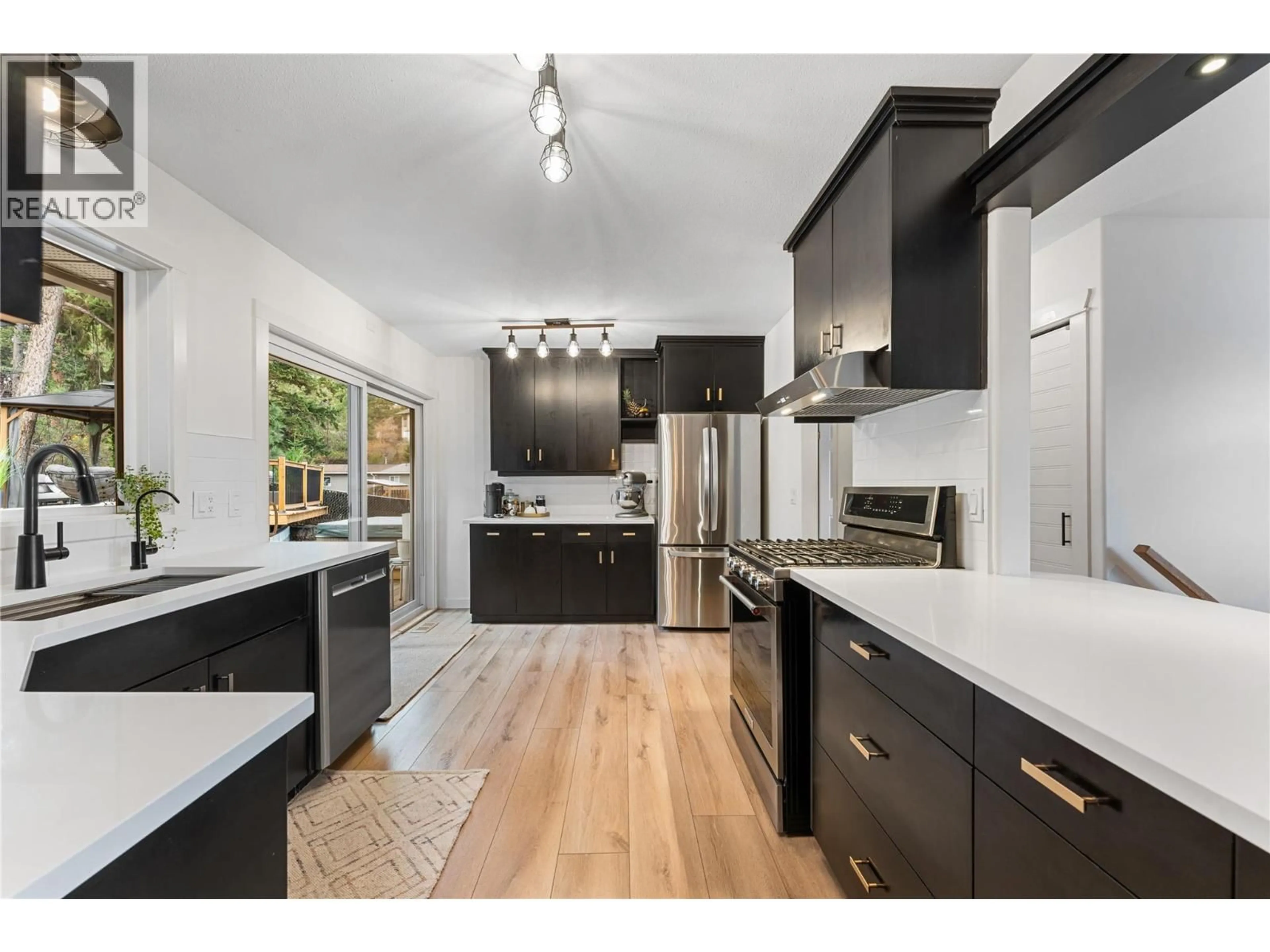 Open concept kitchen, wood/laminate floor for 3380 MCIVER ROAD, West Kelowna British Columbia V4T1H7