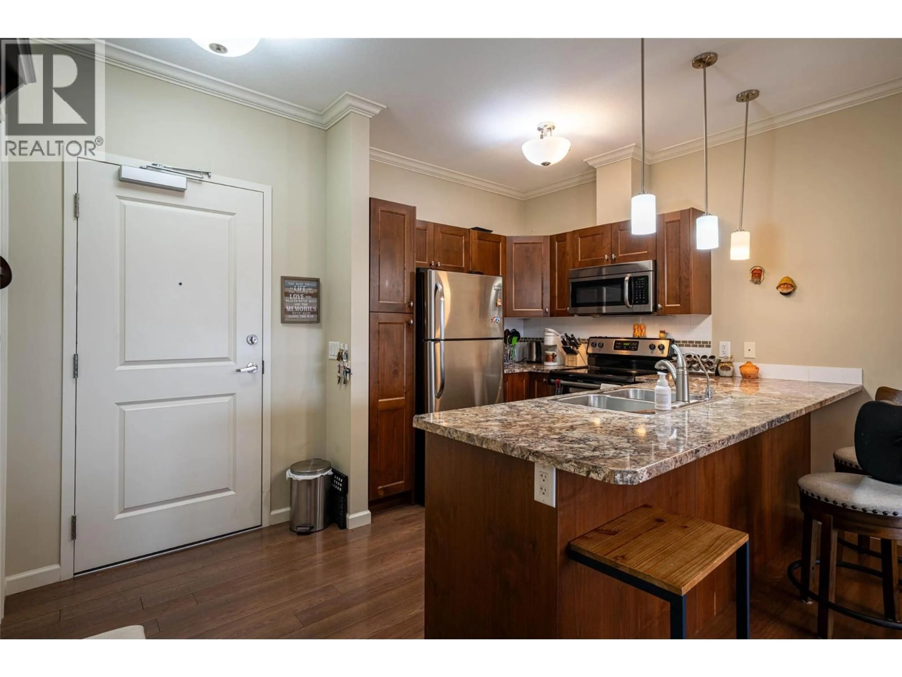 Open concept kitchen, wood/laminate floor for 402 - 3010 35 STREET, Vernon British Columbia V1T0A7