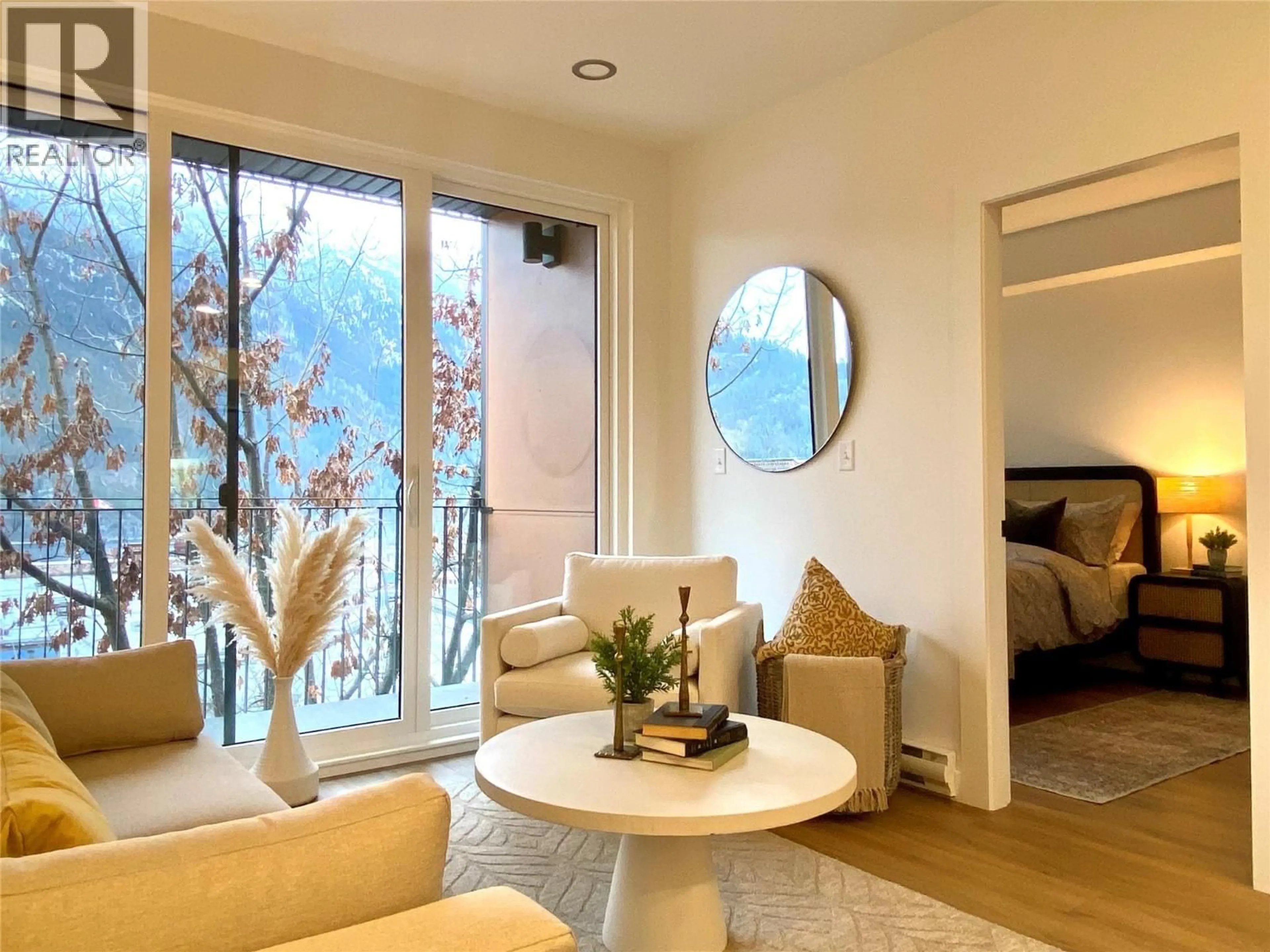 Living room with furniture, wood/laminate floor for 404 - 514 VICTORIA STREET, Nelson British Columbia V1L4K8