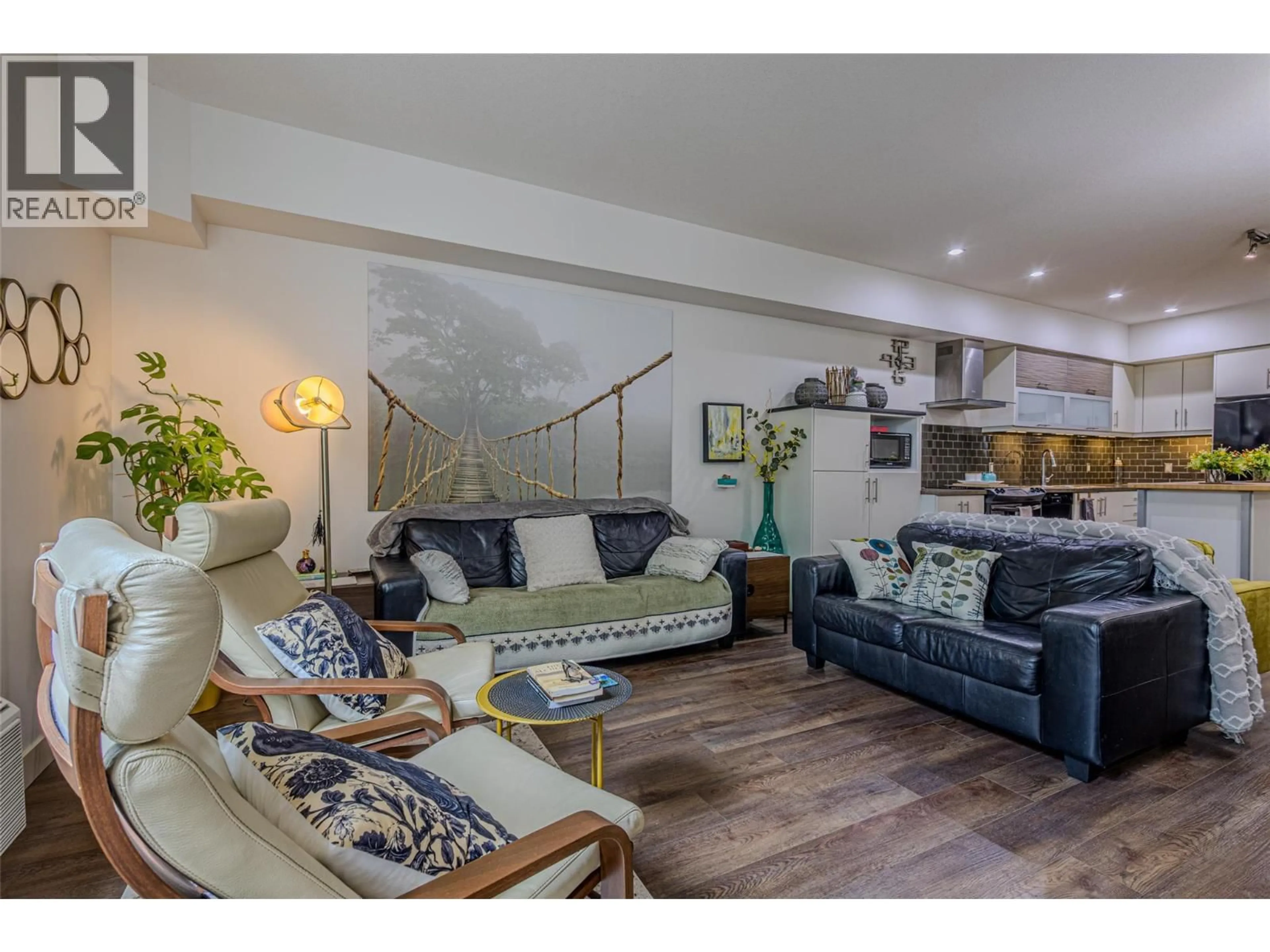 Living room with furniture, wood/laminate floor for 106 - 700 MARTIN AVENUE, Kelowna British Columbia V1Y6V3