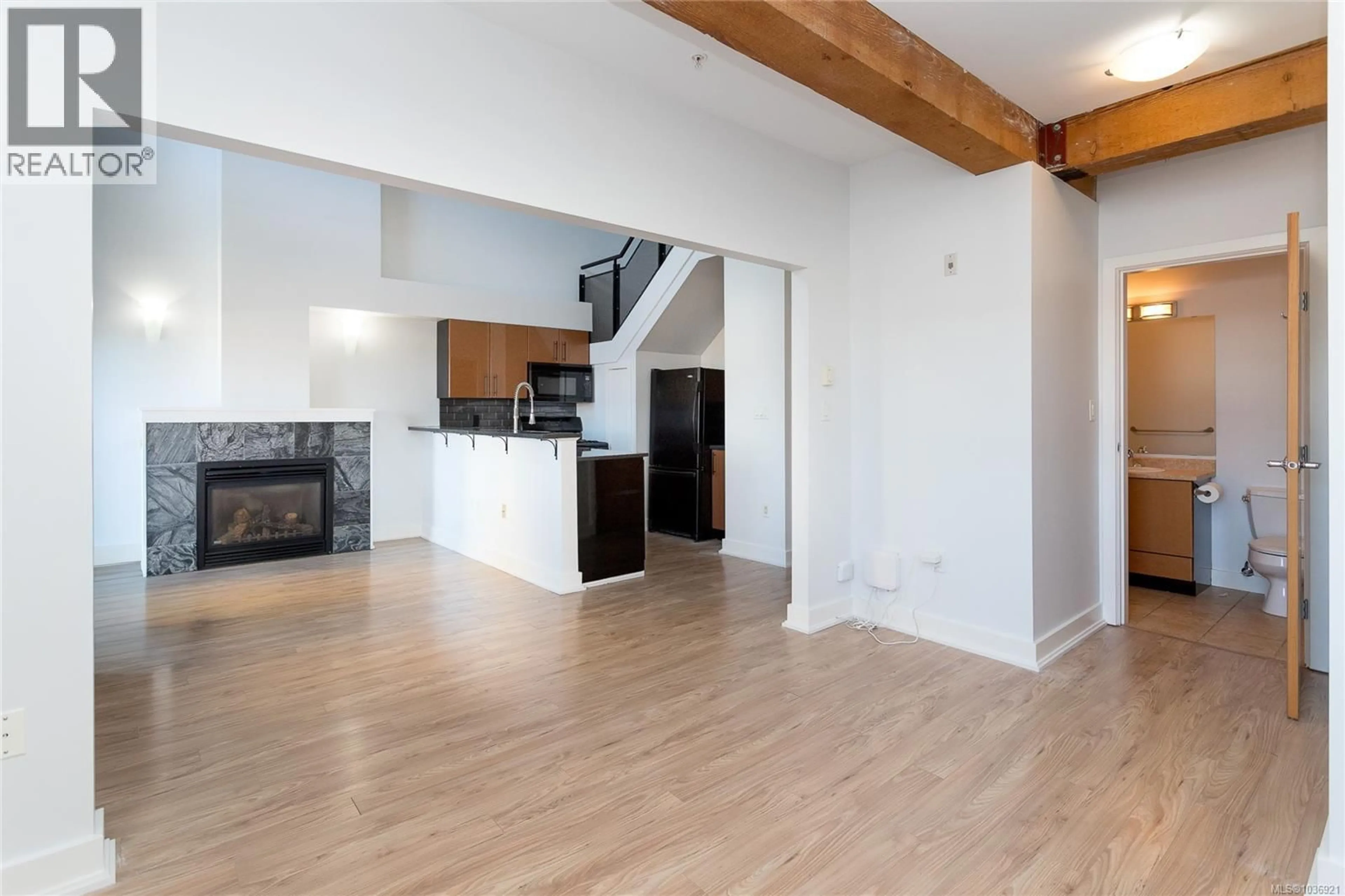 Open concept kitchen, wood/laminate floor for 323 - 599 PANDORA AVENUE, Victoria British Columbia V8W1N5