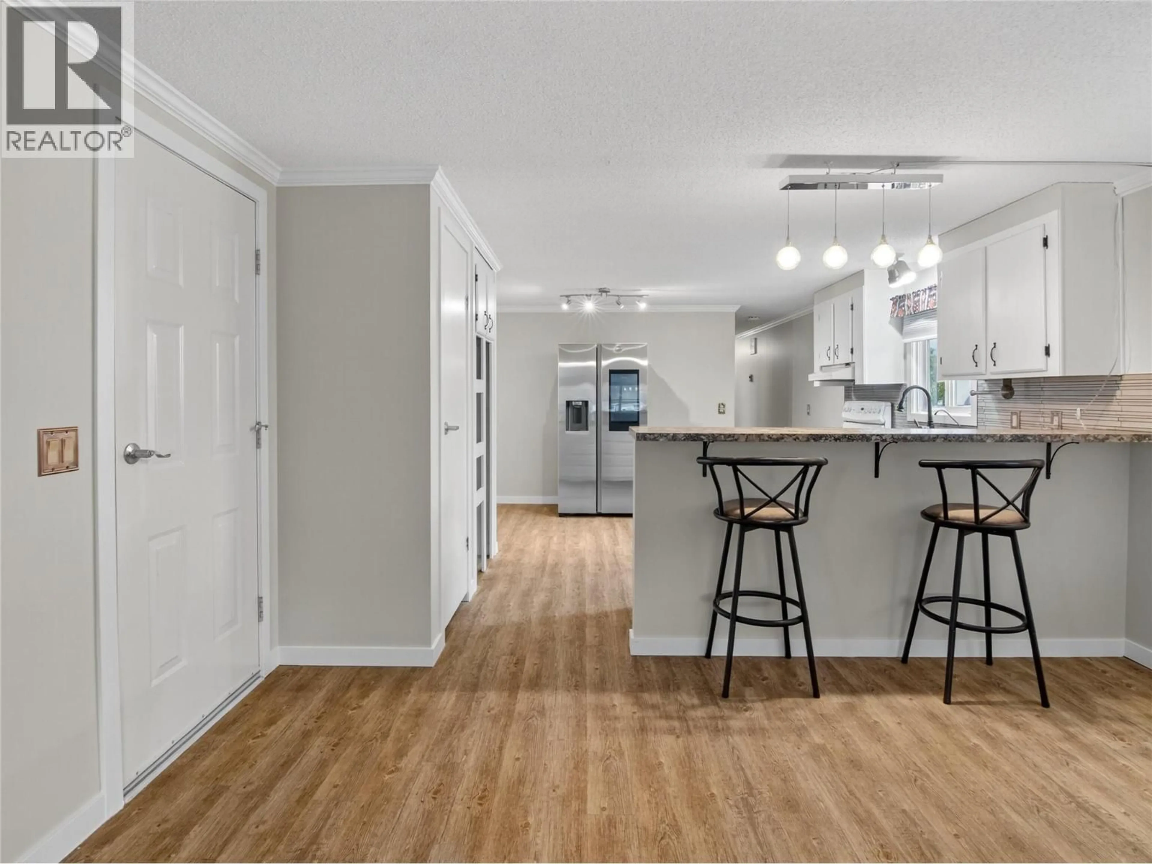 Open concept kitchen, wood/laminate floor for 108 - 98 OKANAGAN AVENUE EAST, Penticton British Columbia V2A3J5