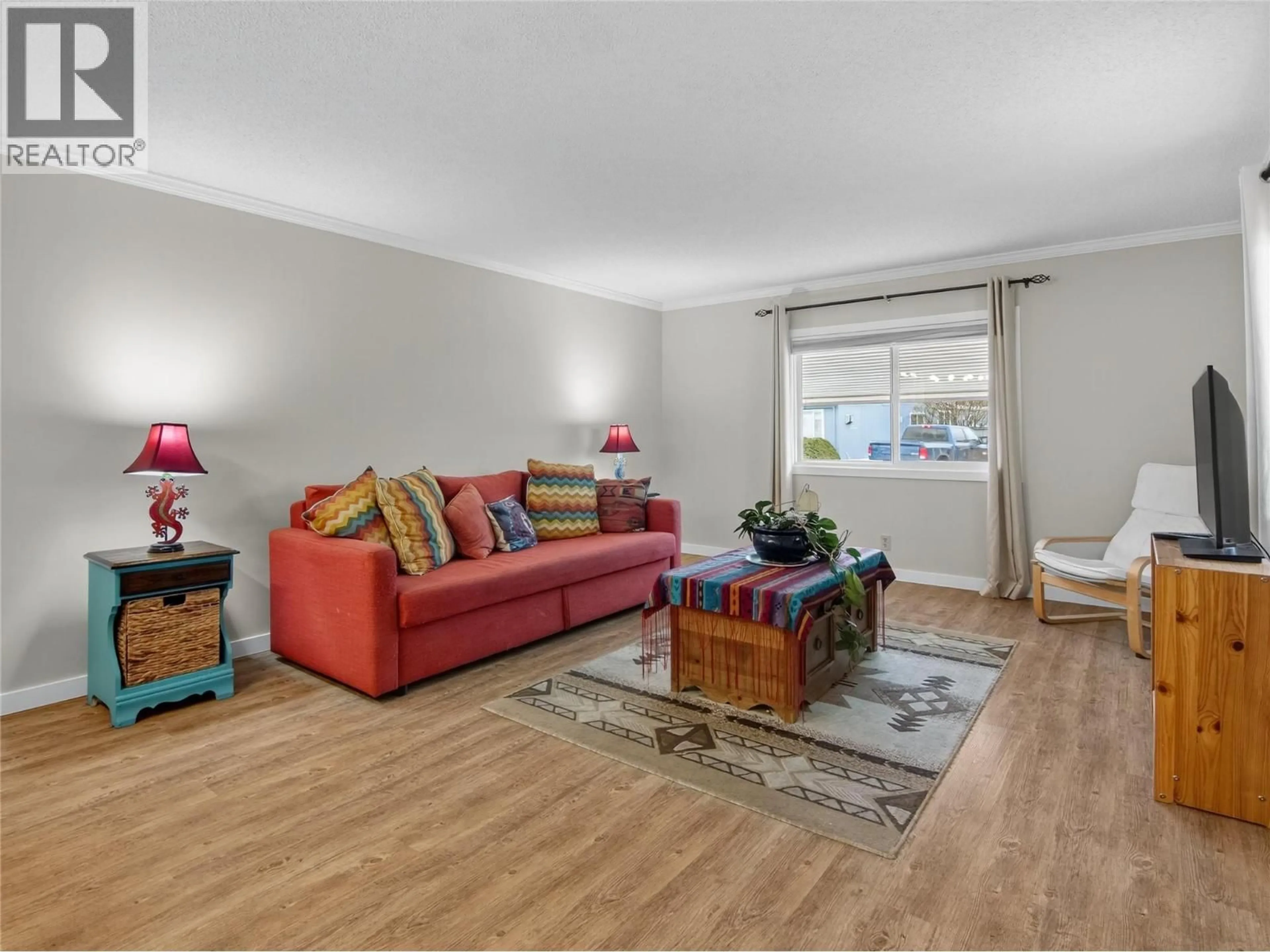 Living room with furniture, wood/laminate floor for 108 - 98 OKANAGAN AVENUE EAST, Penticton British Columbia V2A3J5
