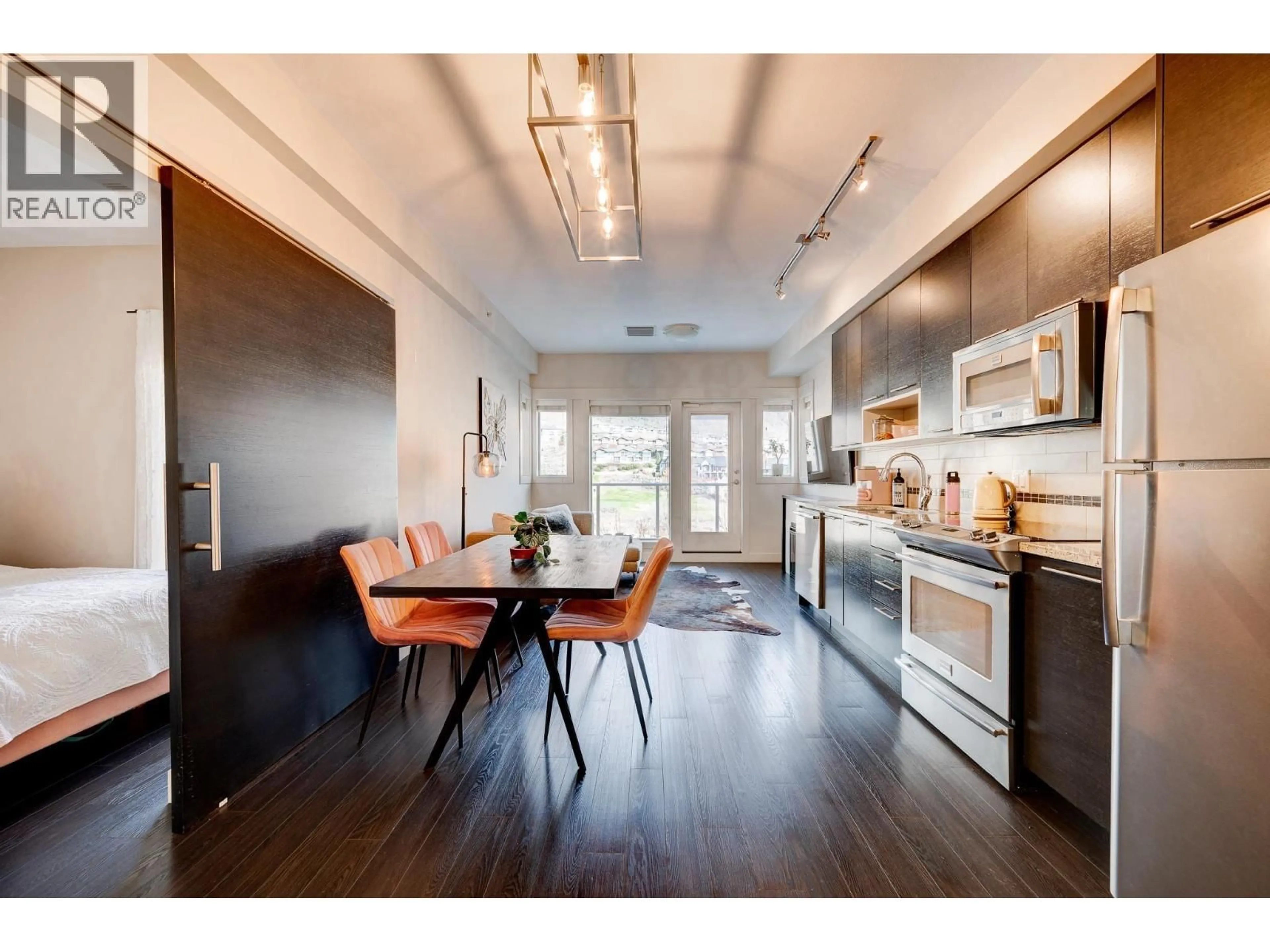 Open concept kitchen, wood/laminate floor for 3421 - 1040 TALASA COURT, Kamloops British Columbia V2H1R1