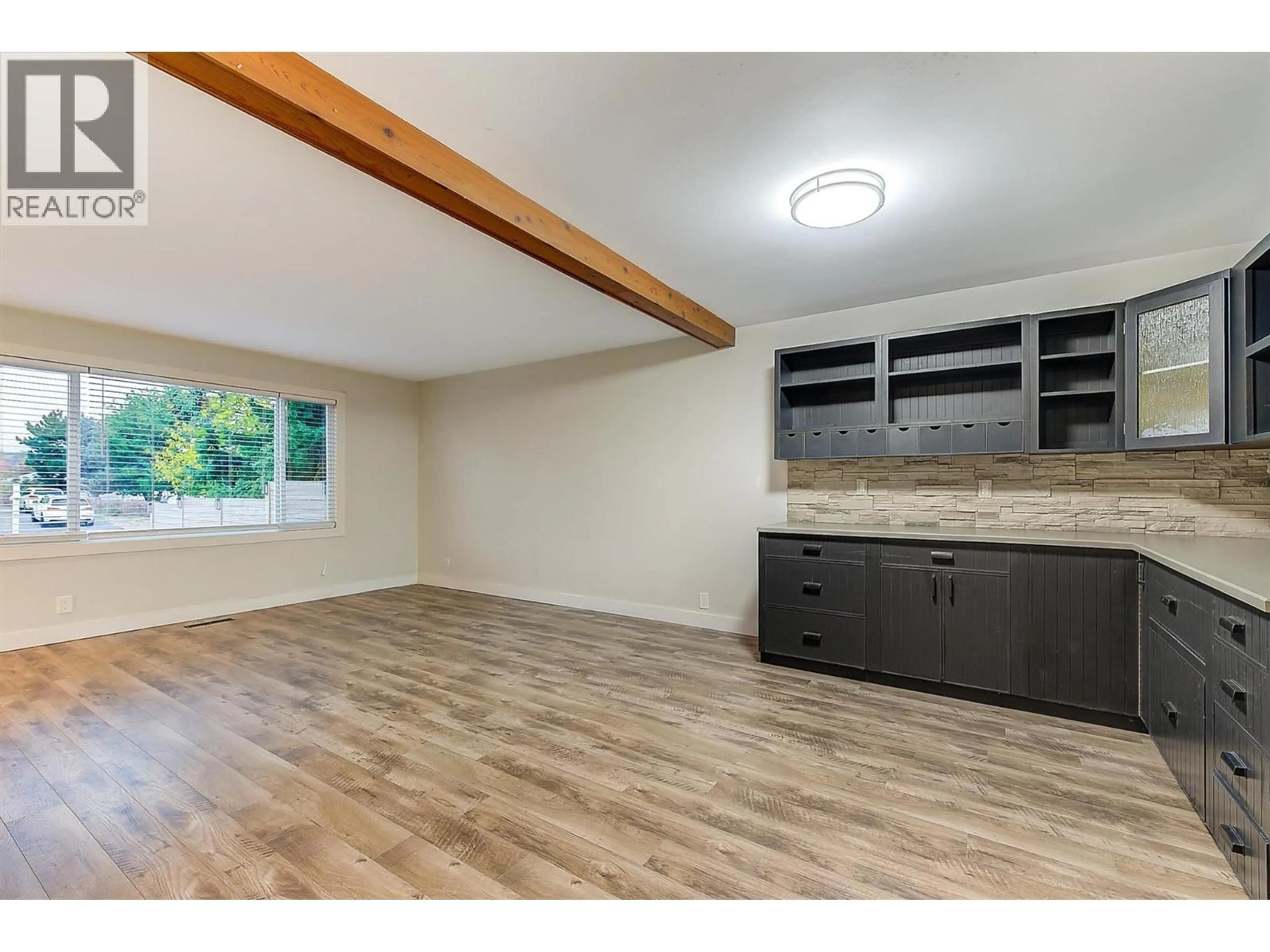Open concept kitchen, wood/laminate floor for 880 HOLLYDELL ROAD, Kelowna British Columbia V1X1L7