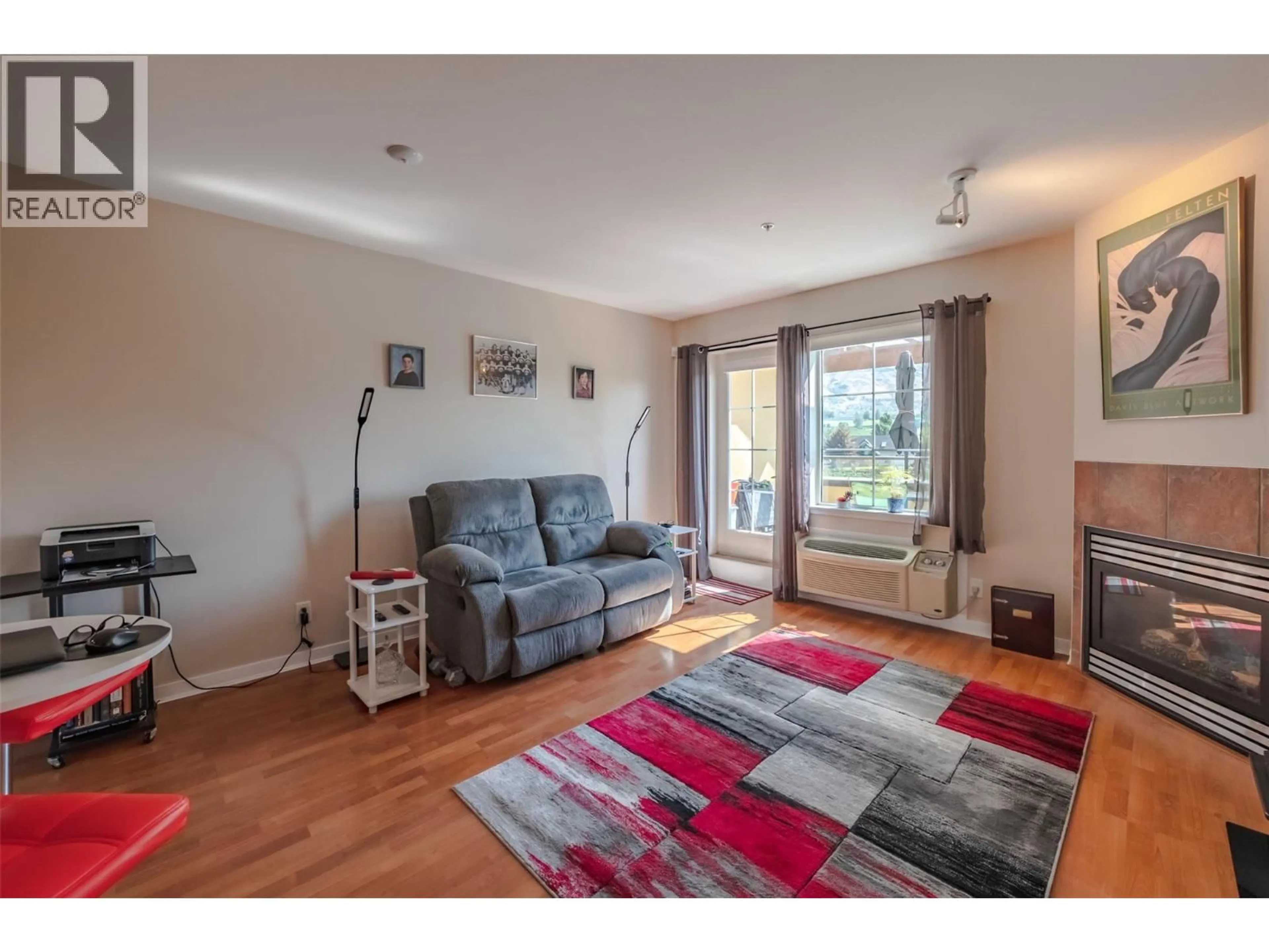 Living room with furniture, wood/laminate floor for 404 - 7600 COTTONWOOD DRIVE, Osoyoos British Columbia V0H1V0