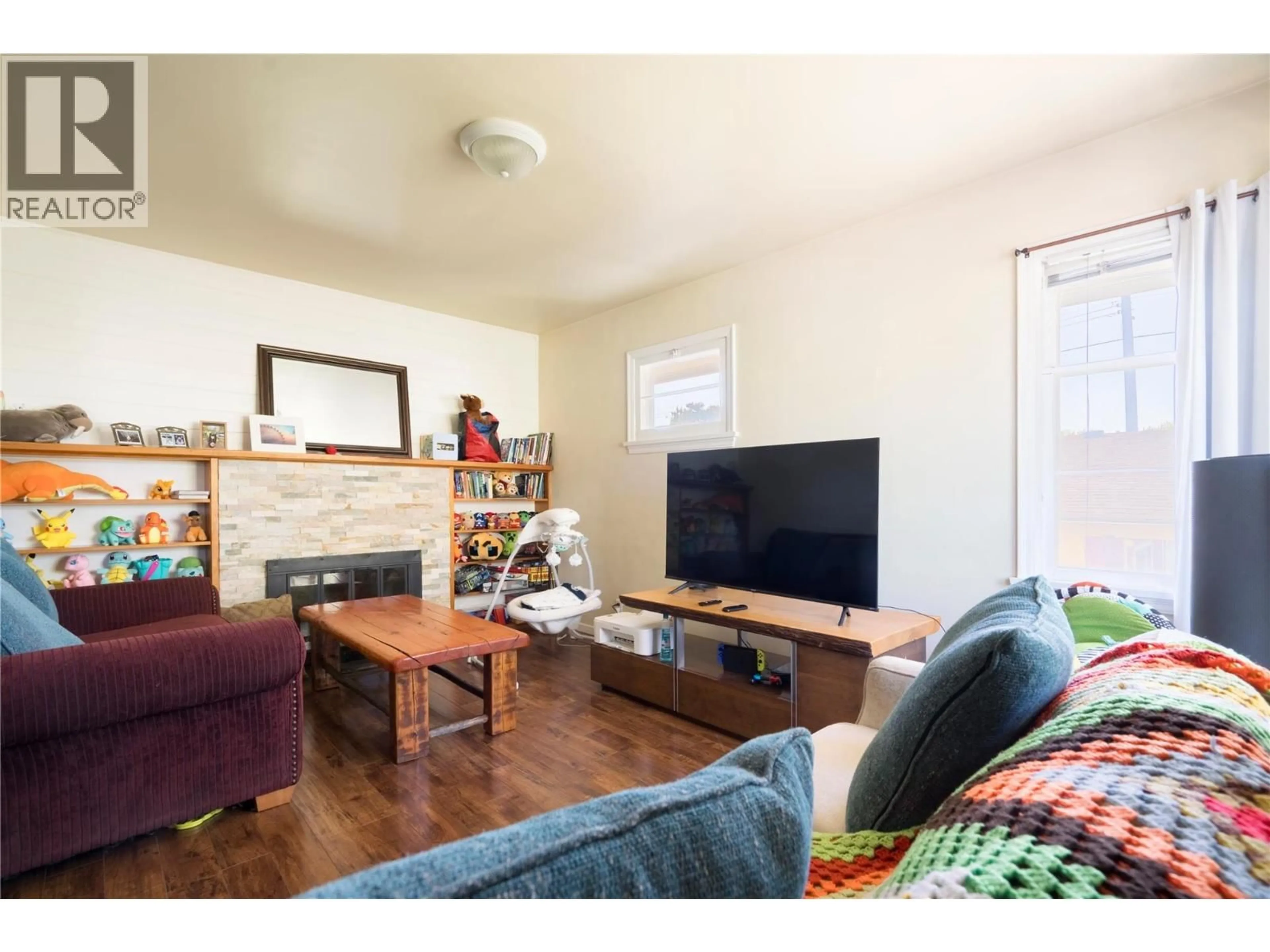 Living room with furniture, wood/laminate floor for 3095 GORDON DRIVE, Kelowna British Columbia V1W3R1