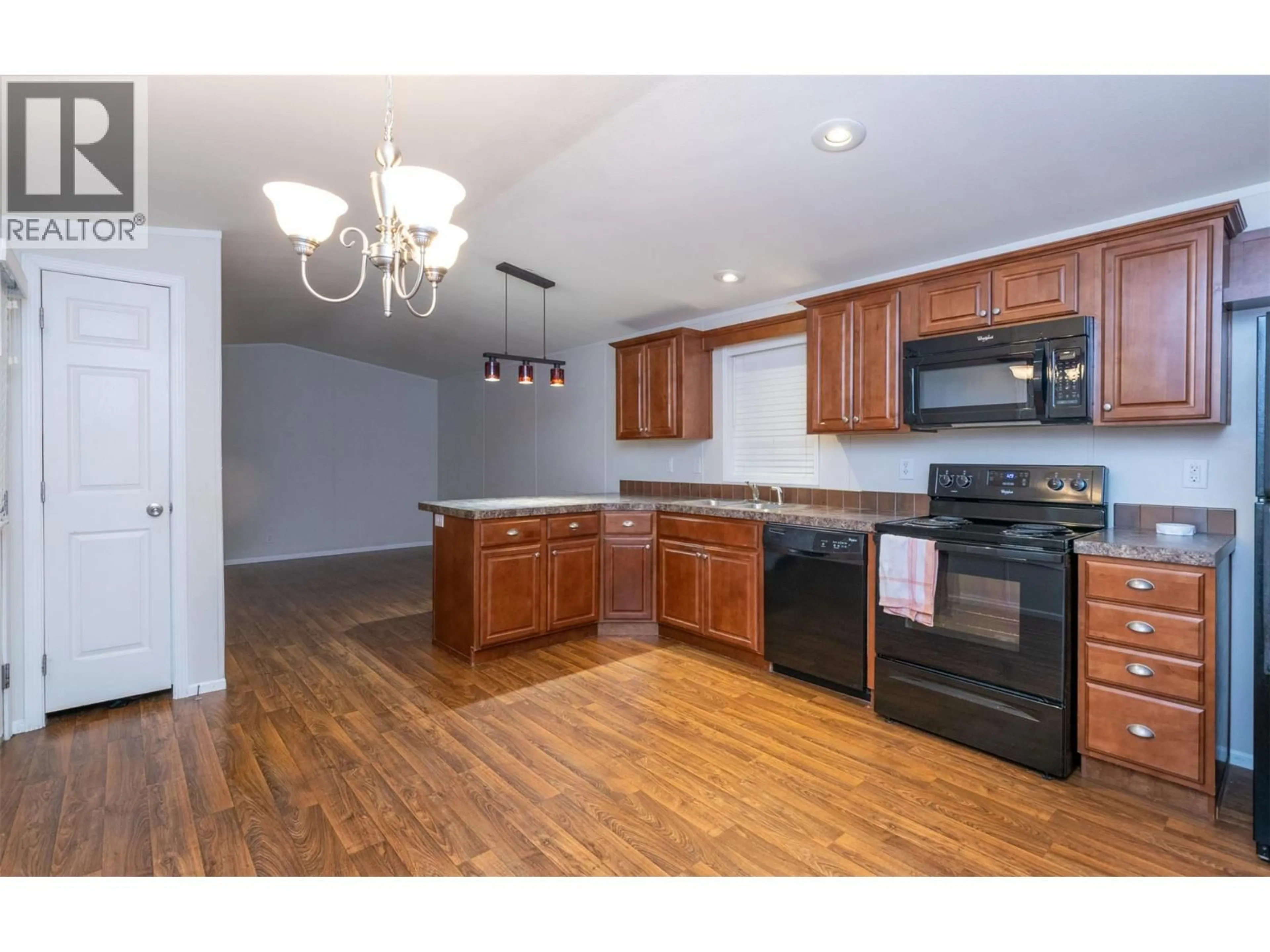 Open concept kitchen, wood/laminate floor for 7 - 5581 MAYFAIR ROAD, Salmon Arm British Columbia V1E4M3