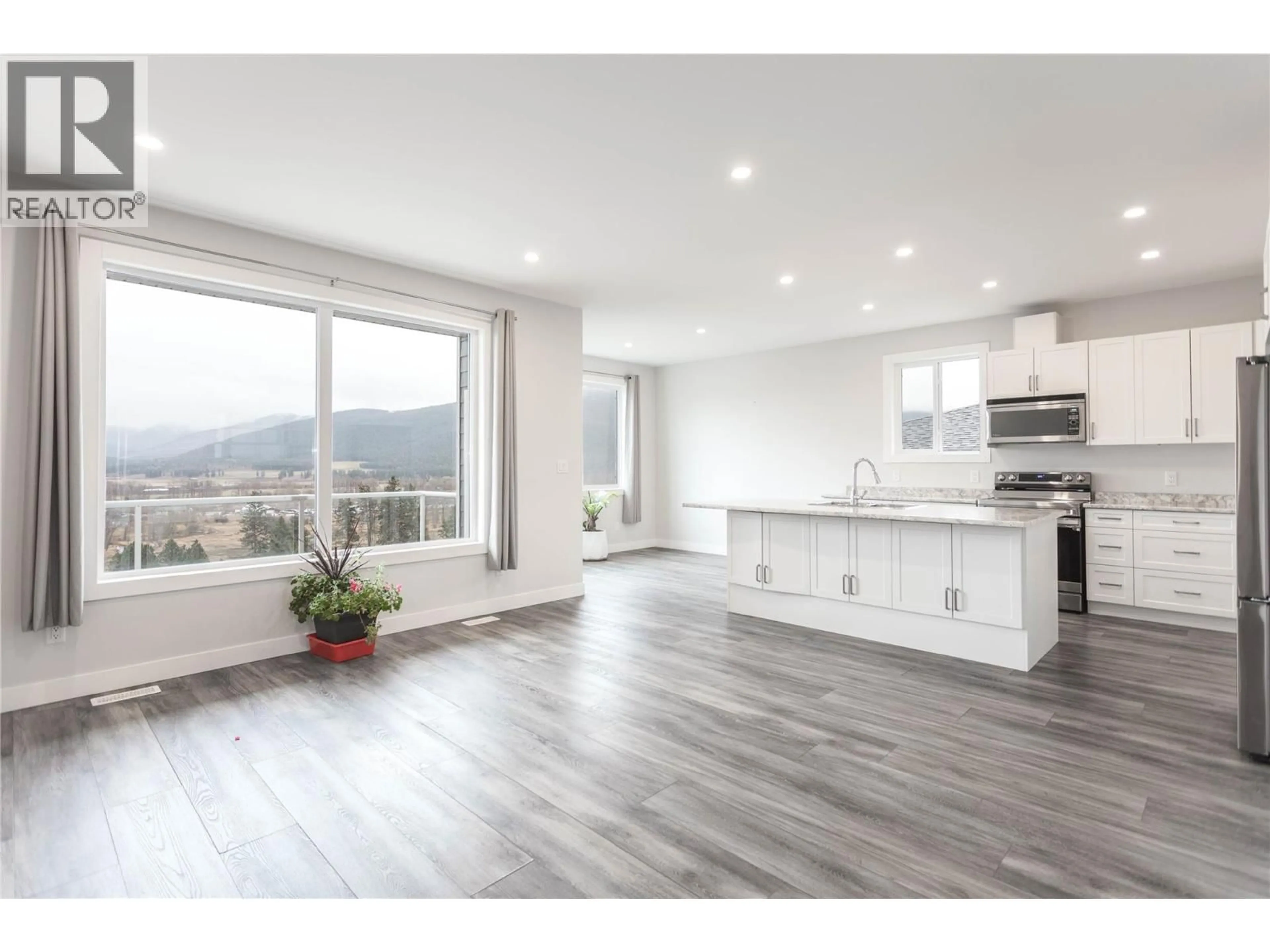 Open concept kitchen, wood/laminate floor for 1807 GALLON AVENUE, Lumby British Columbia V0E2G0