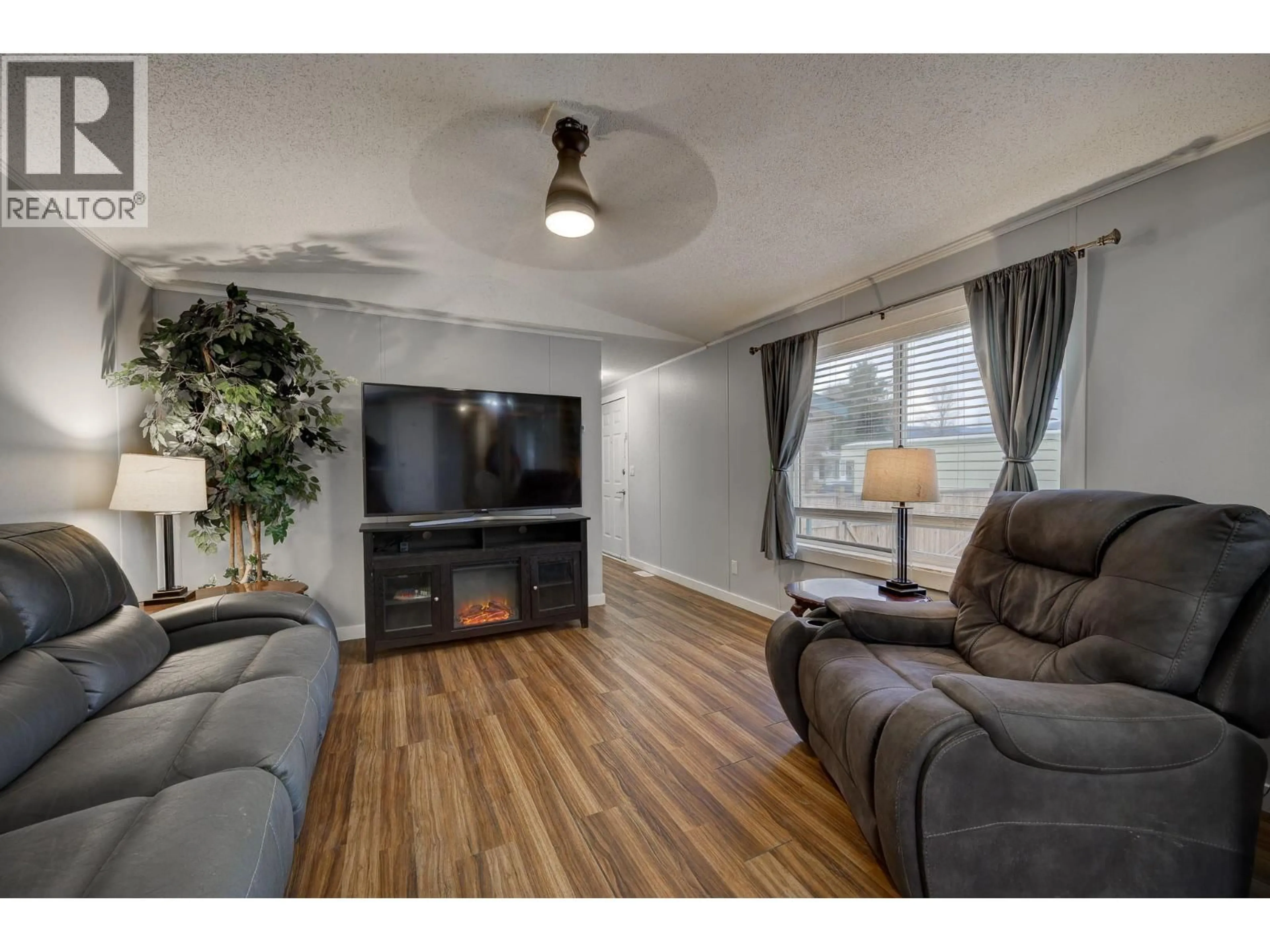 Living room with furniture, wood/laminate floor for E6 - 220 G & M ROAD, Kamloops British Columbia V2H1A4