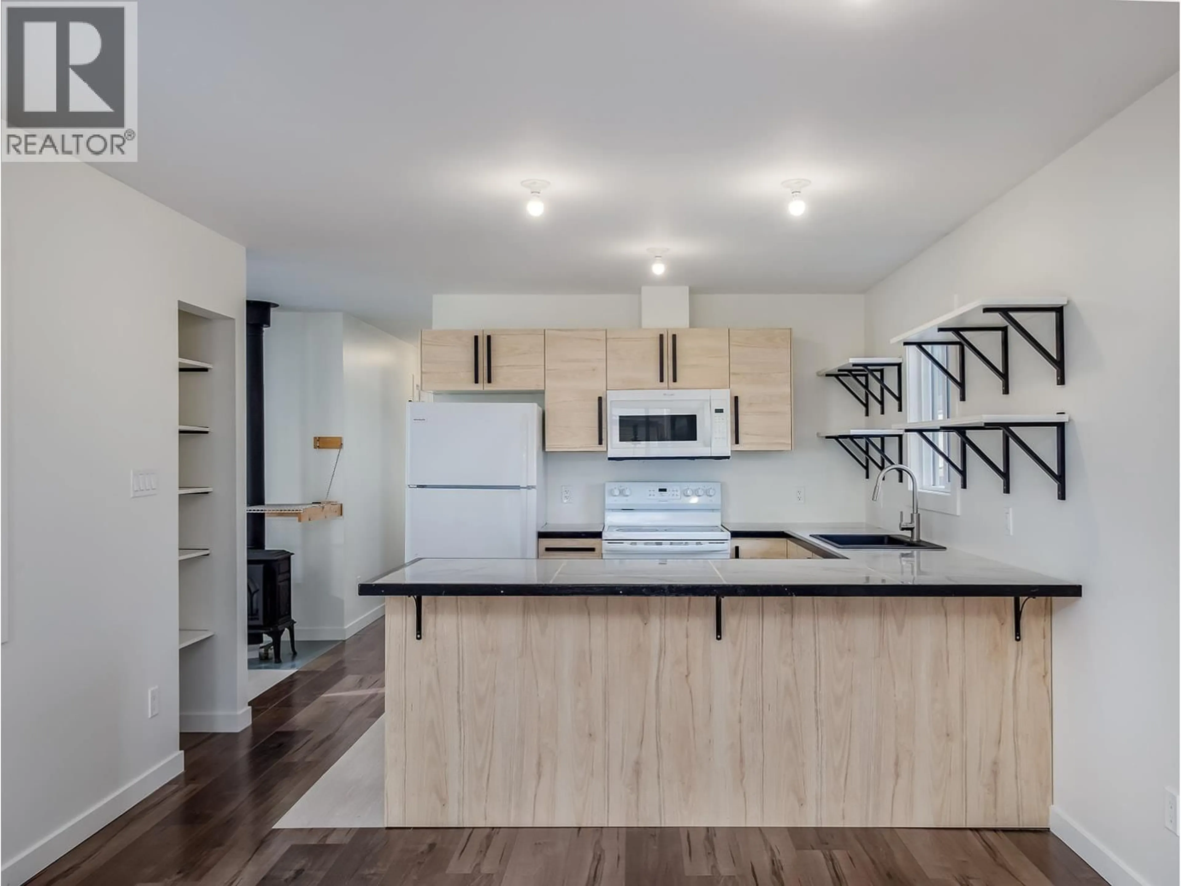 Open concept kitchen, wood/laminate floor for 9 - 1117 10TH AVENUE NORTH, Golden British Columbia V0A1H3