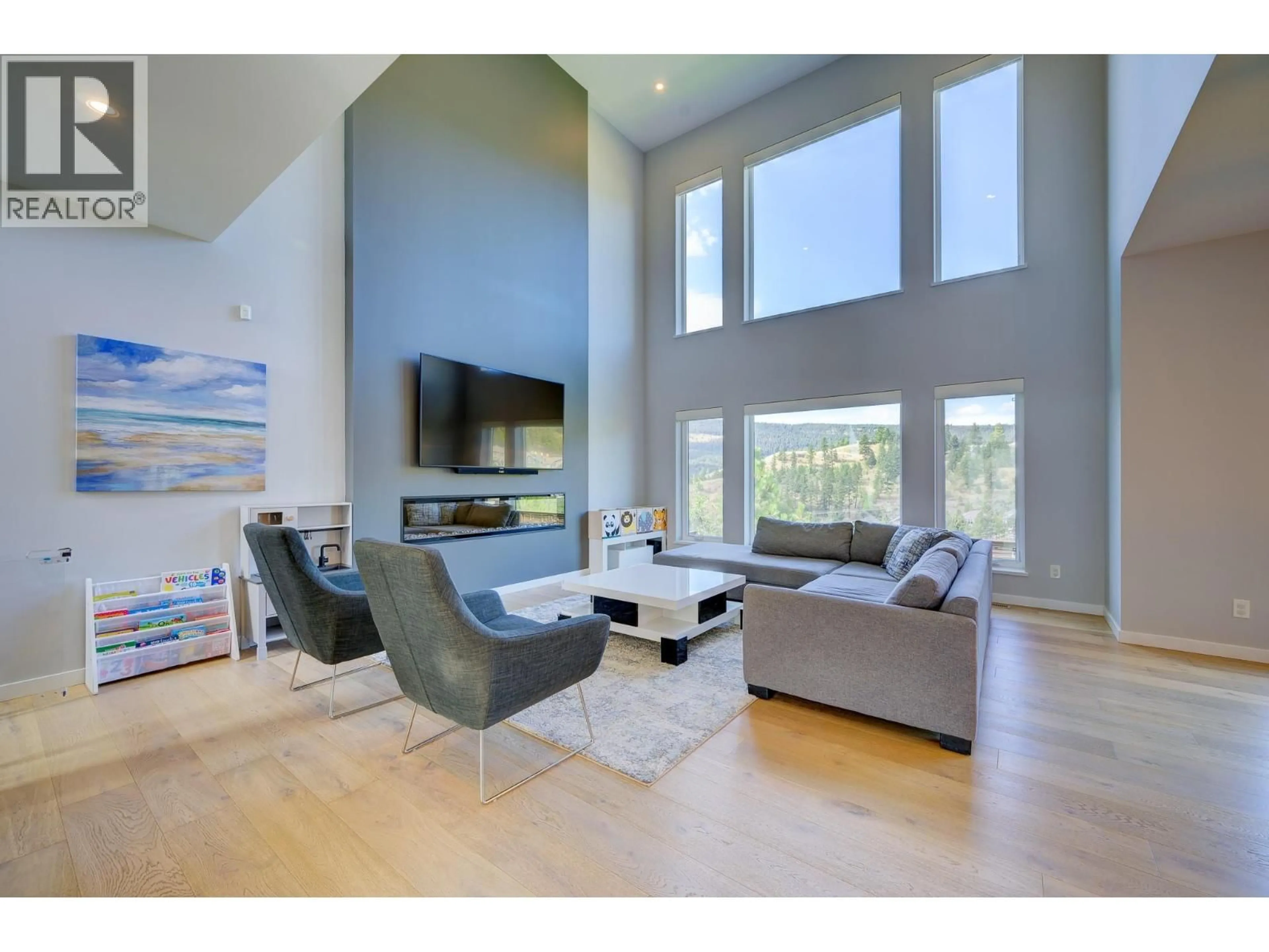 Living room with furniture, wood/laminate floor for 1312 PRAIRIE ROSE DRIVE, Kamloops British Columbia V2E0C5