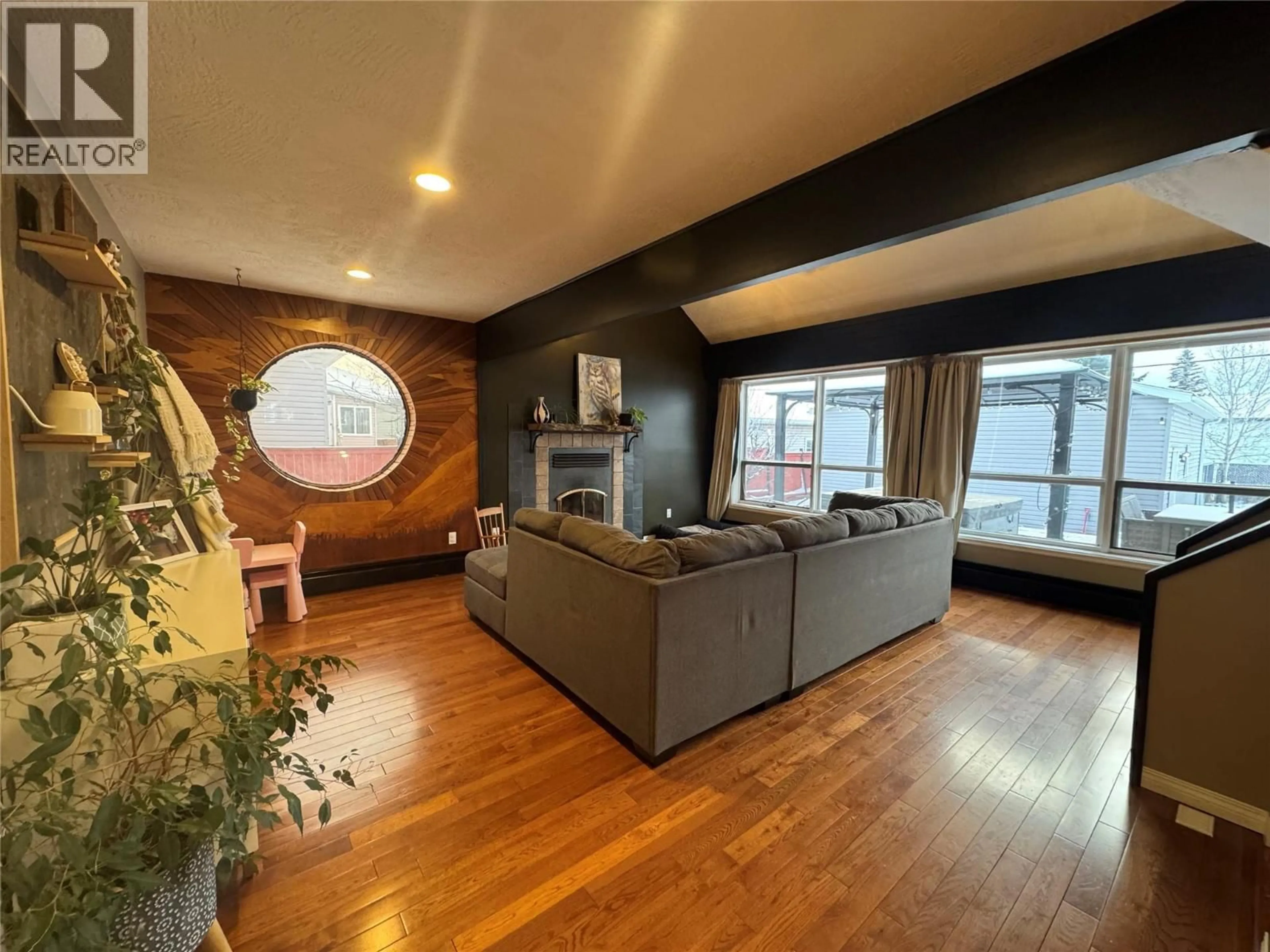 Living room with furniture, wood/laminate floor for 1605 108 AVENUE, Dawson Creek British Columbia V1G2T5