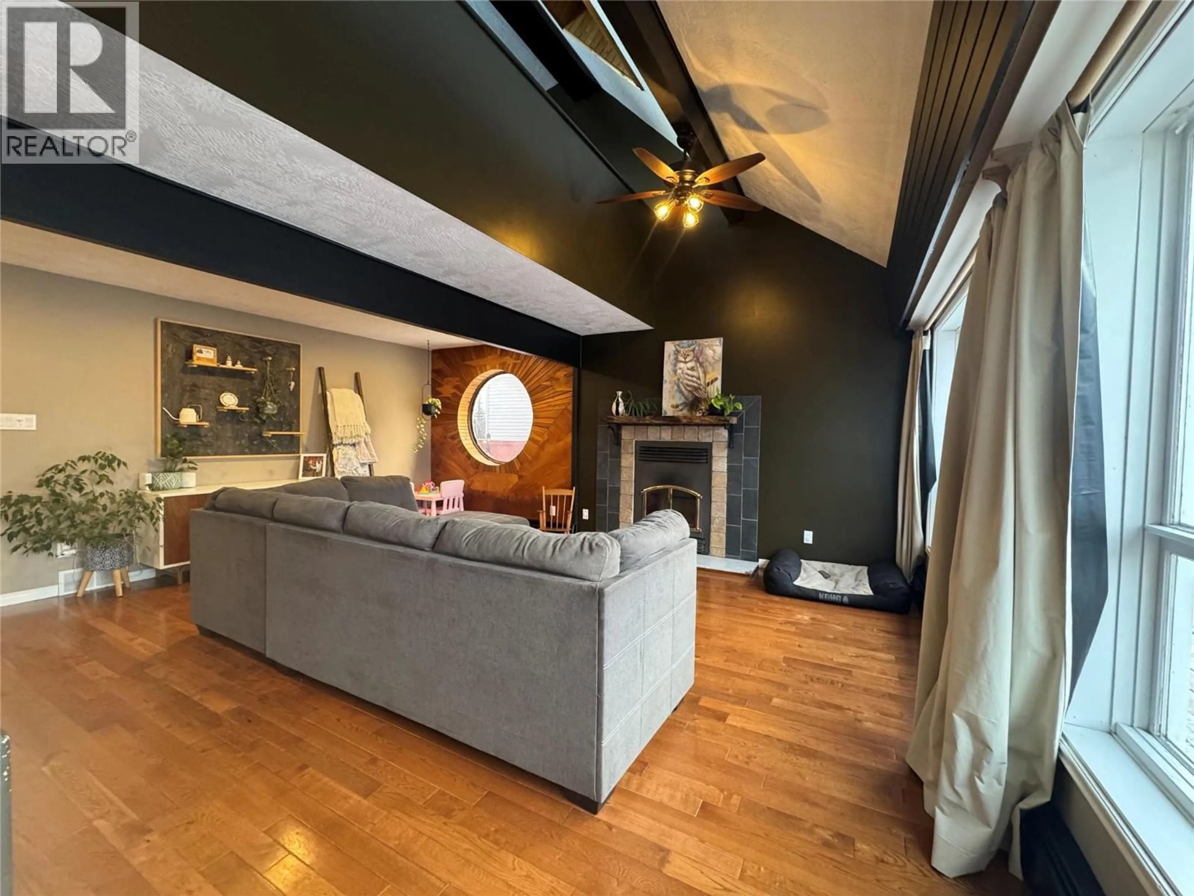 Living room with furniture, wood/laminate floor for 1605 108 AVENUE, Dawson Creek British Columbia V1G2T5