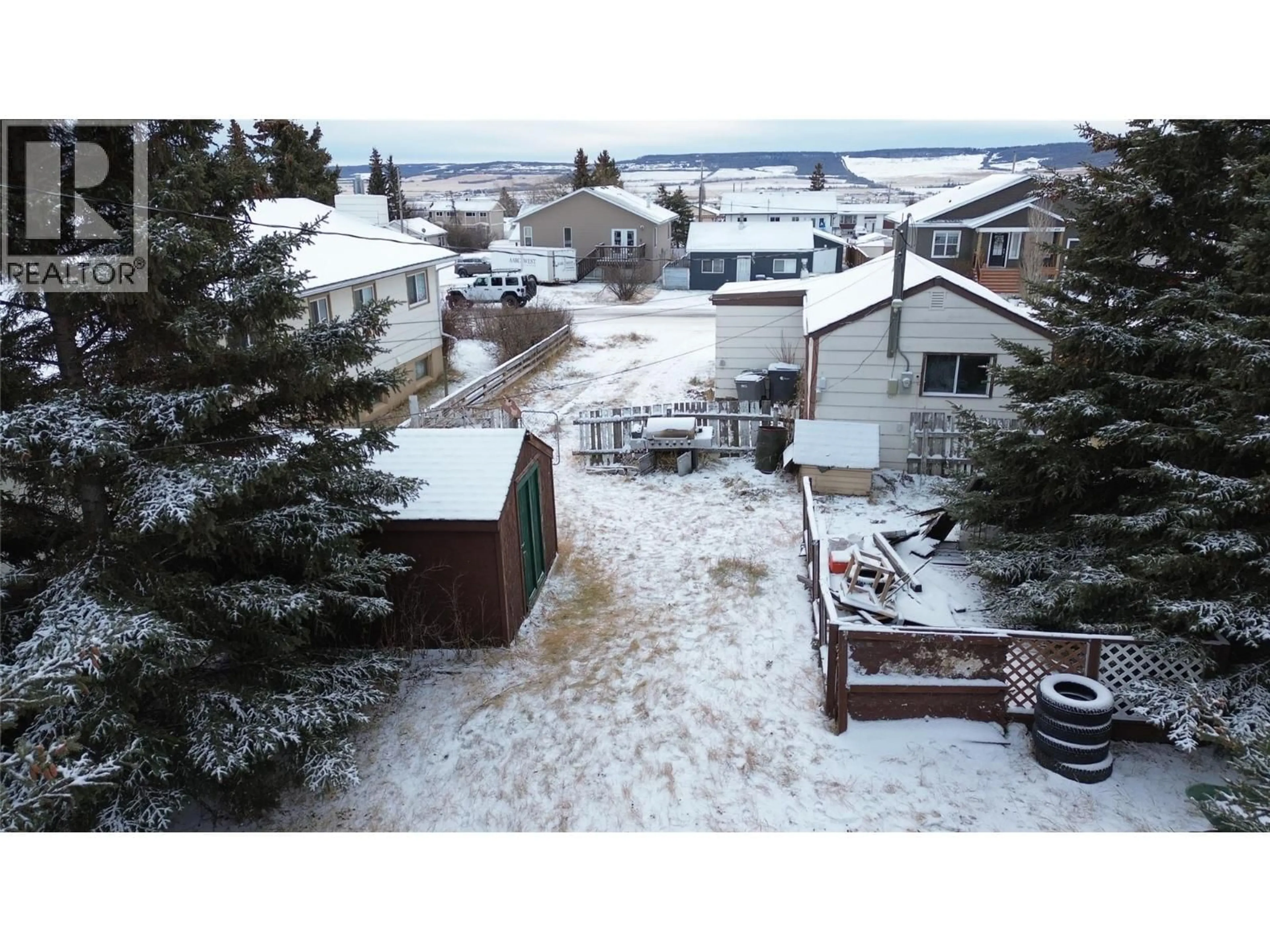 A pic from outside/outdoor area/front of a property/back of a property/a pic from drone, mountain view for 404 99 AVENUE, Dawson Creek British Columbia V1G1T3