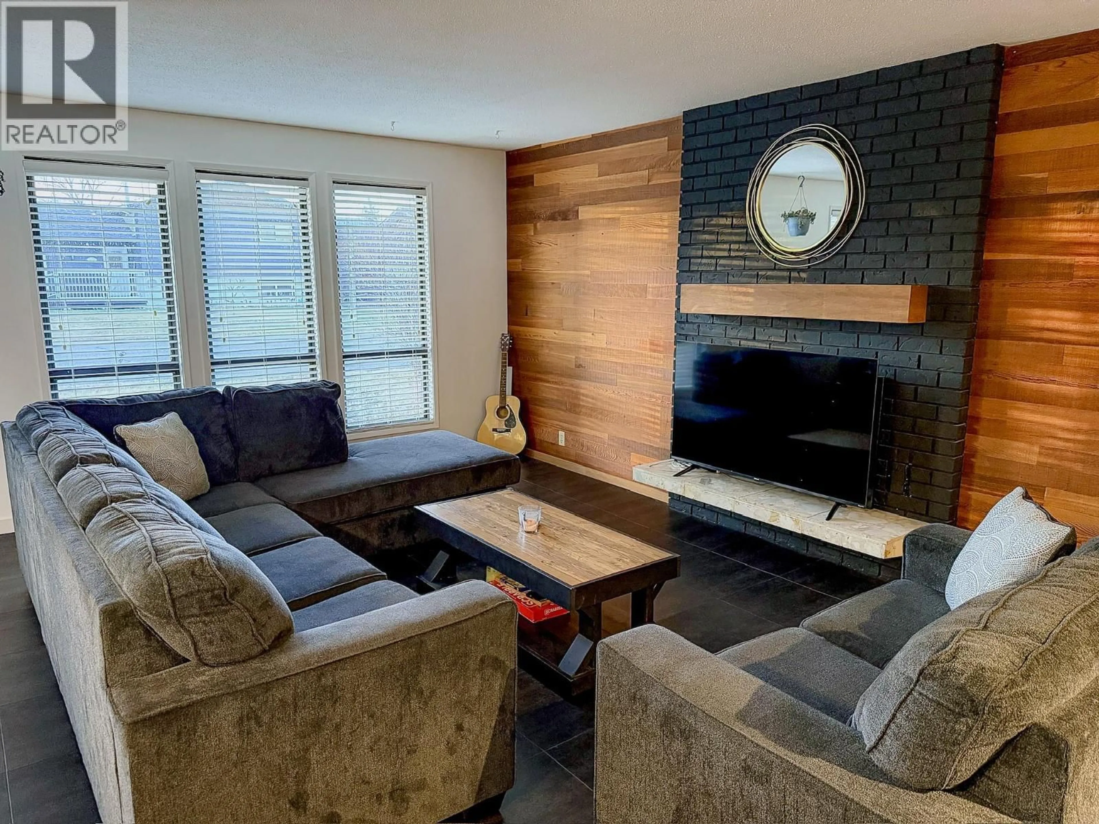 Living room with furniture, wood/laminate floor for 10728 18 STREET, Dawson Creek British Columbia V1G4E2