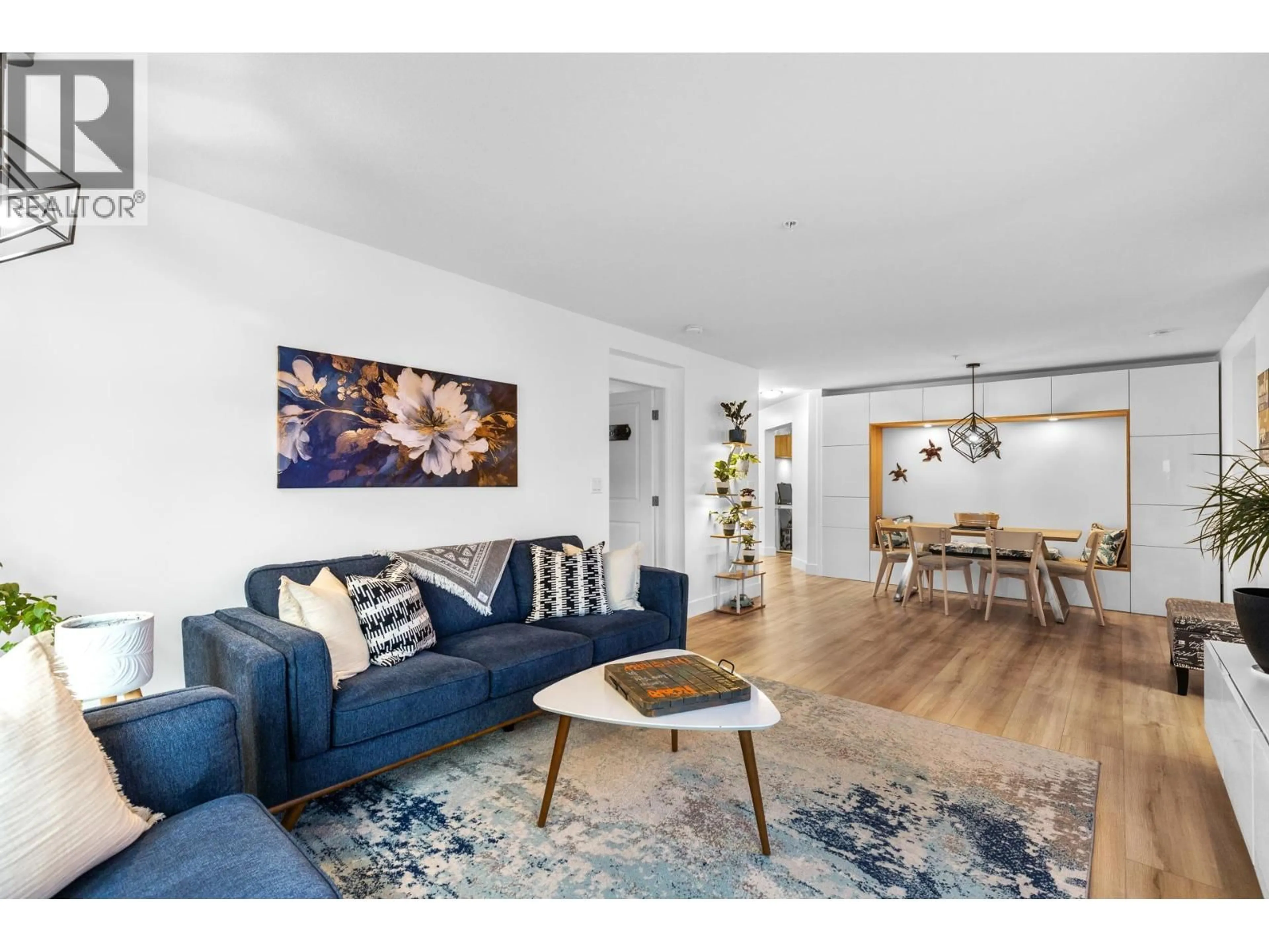 Living room with furniture, wood/laminate floor for 115 - 555 YATES ROAD, Kelowna British Columbia V1V2V2