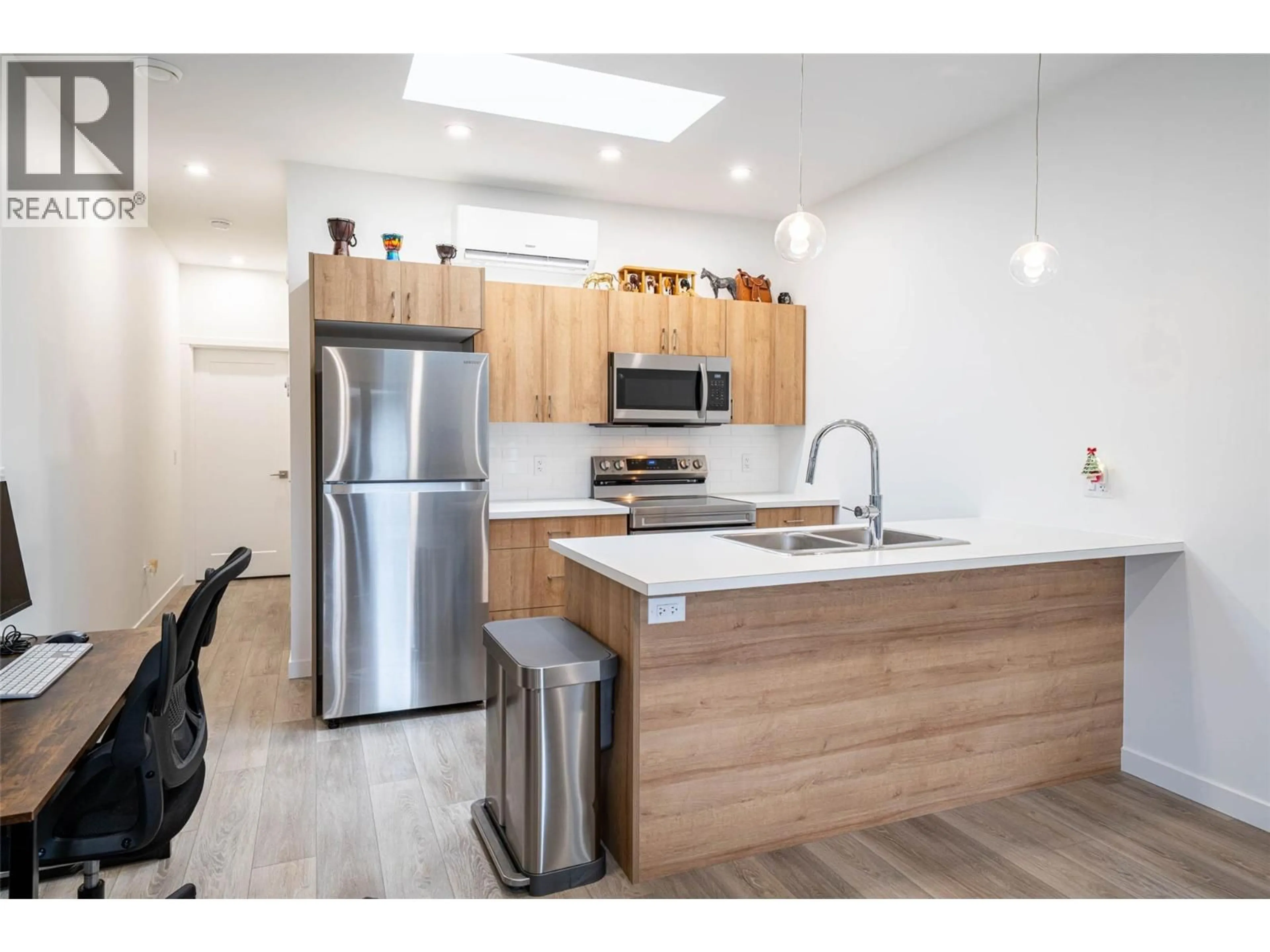 Open concept kitchen, wood/laminate floor for 206E - 8900 JIM BAILEY ROAD, Kelowna British Columbia V4V1E8